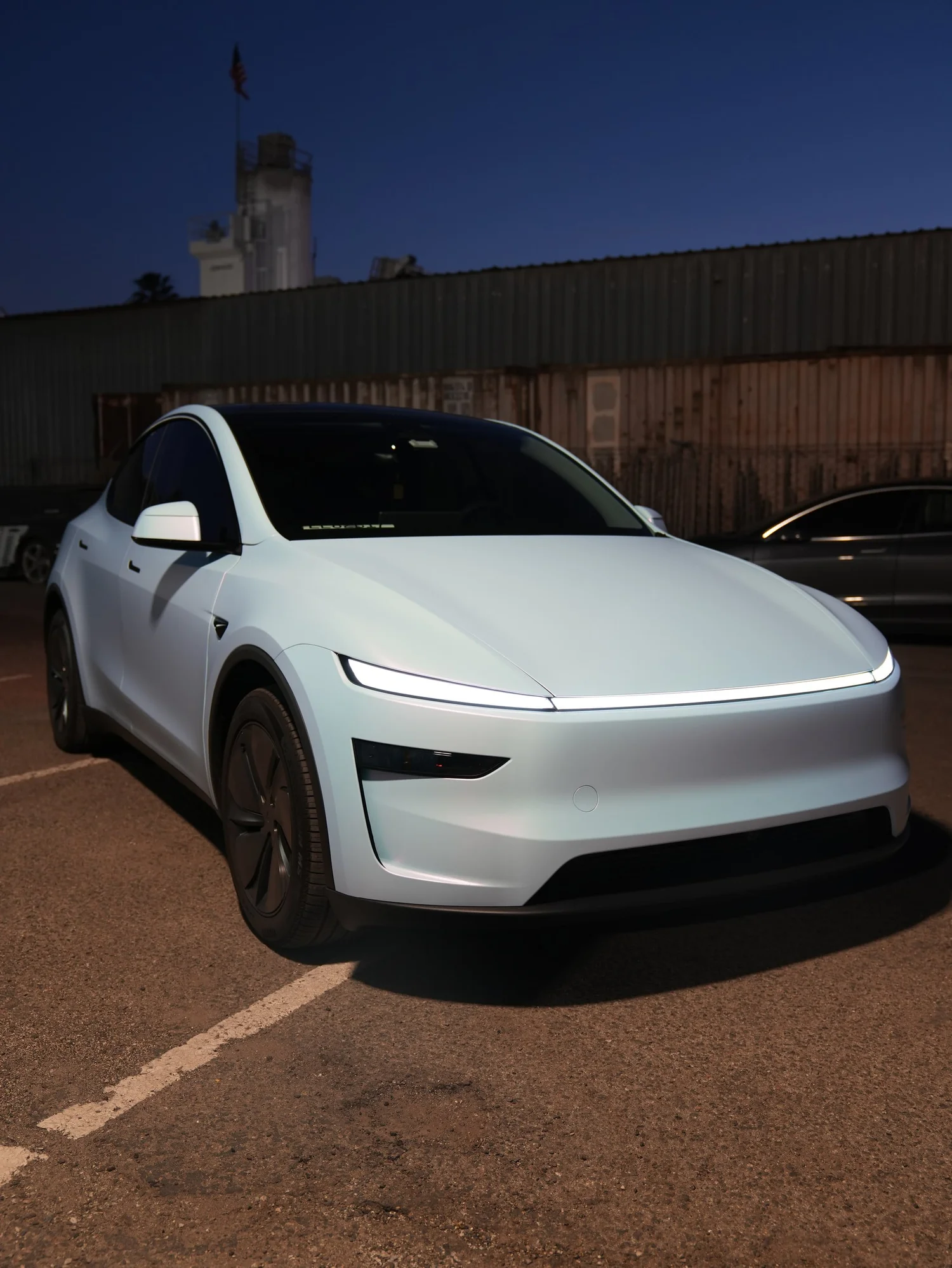 Tesla Model Y Color-Shifting White-to-Blue after Vinyl Wrap, front-right three-quarter view