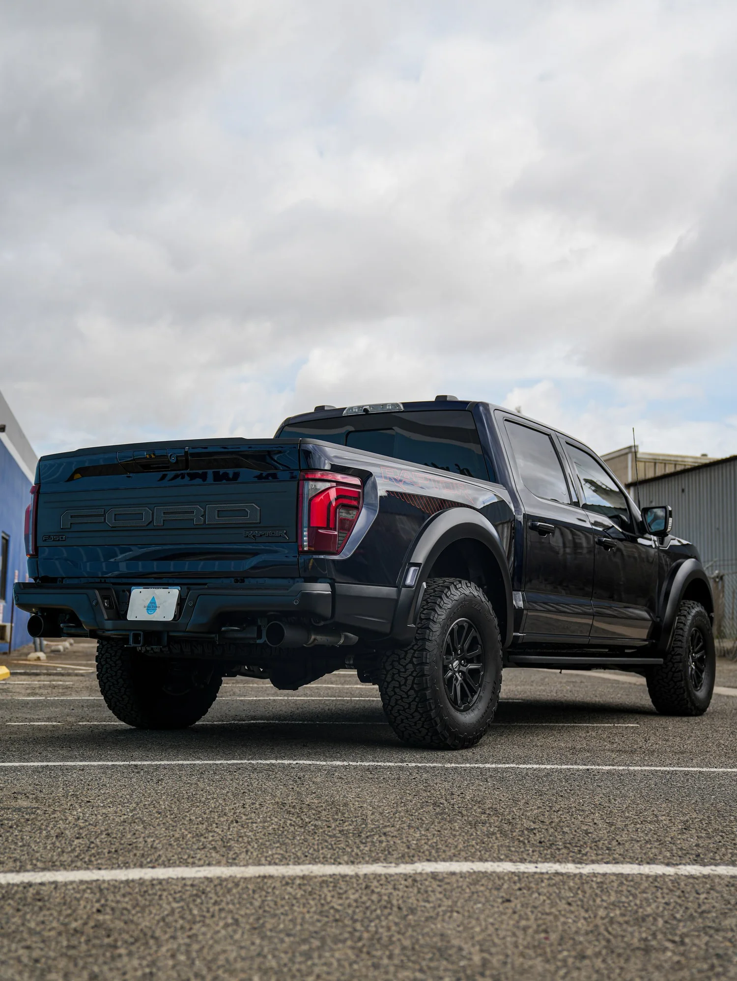 Dark Blue Ford F-150 Raptor after Paint Protection Film (PPF) and Window Tint, rear-left three-quarter view
