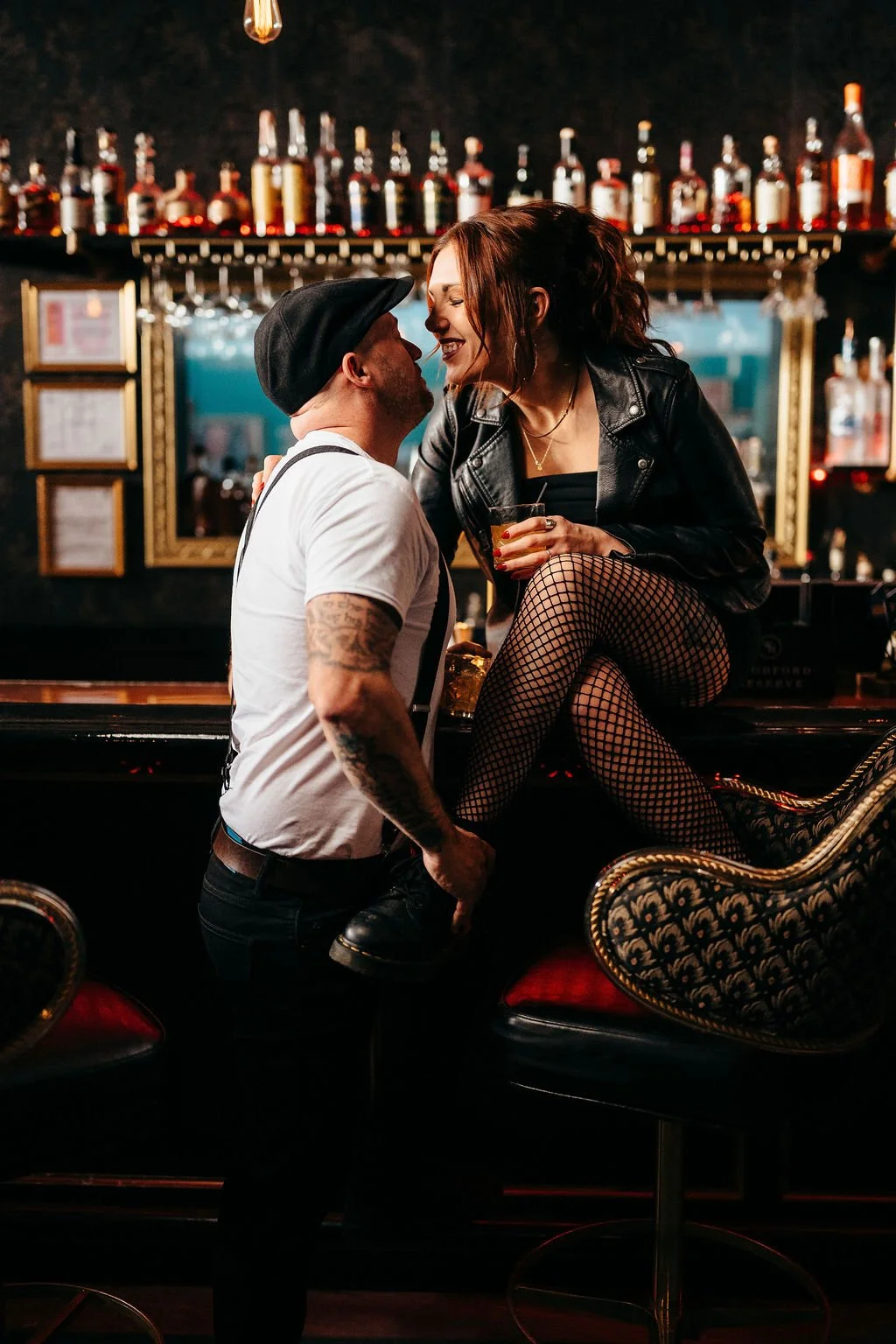 Mike kissing Kristin's cheek as she laughs with a cocktail, Laconia engagement session