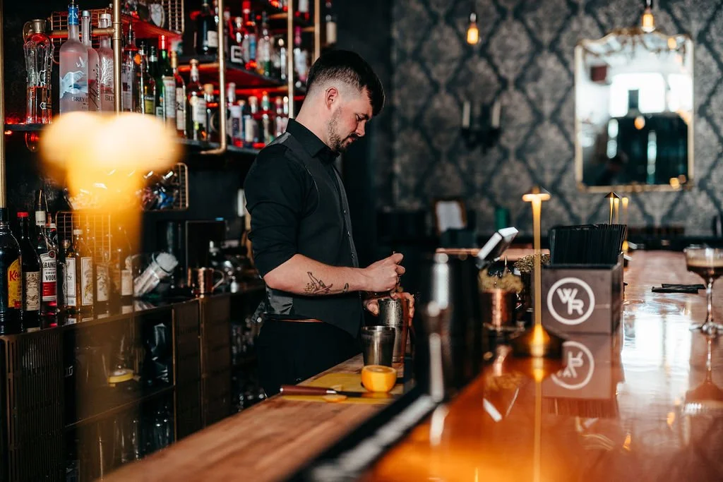 Bartender crafting a cocktail at The Candy Bar, Laconia NH engagement photography