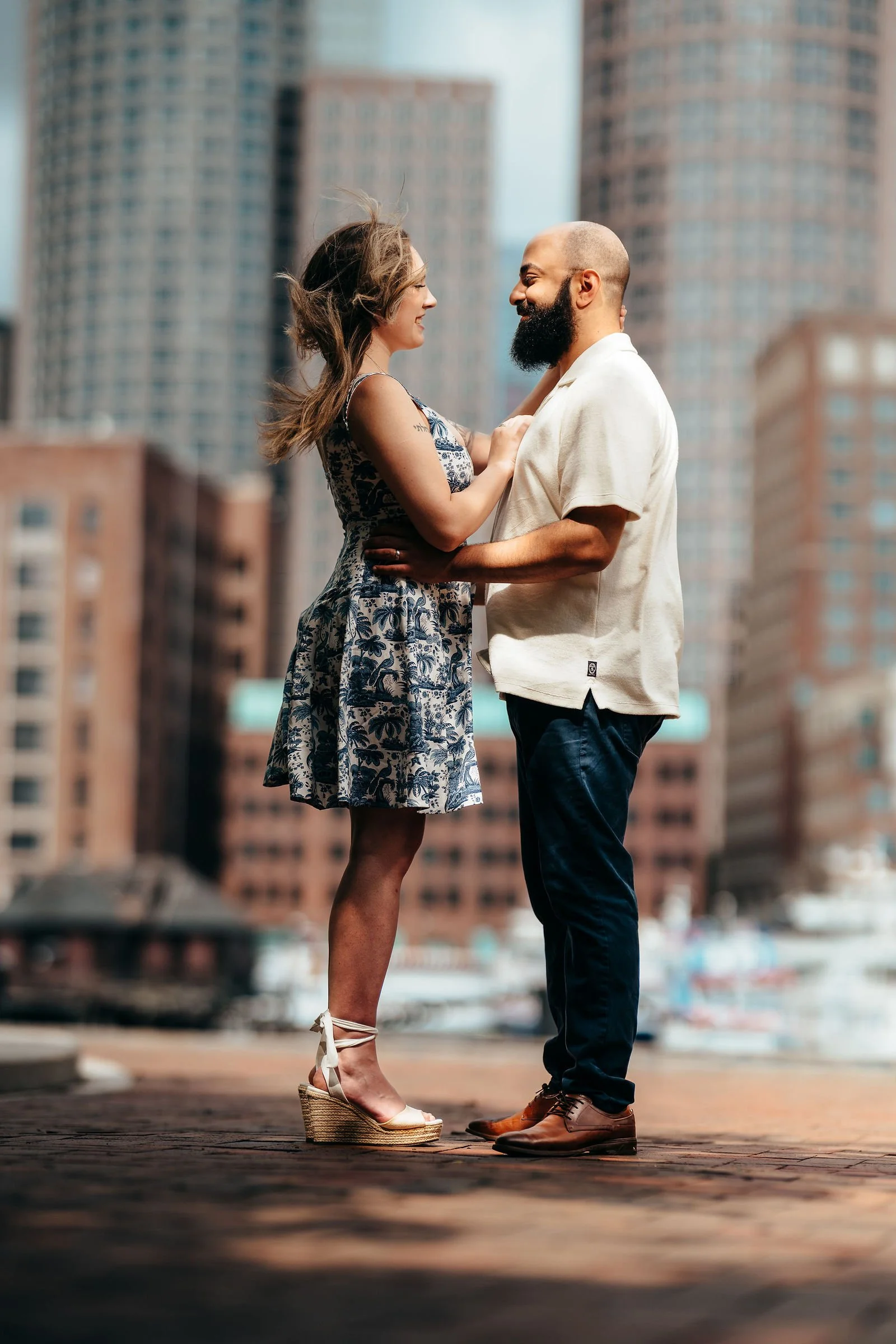 Aziz and Katherine facing each other at sunset, Boston engagement session