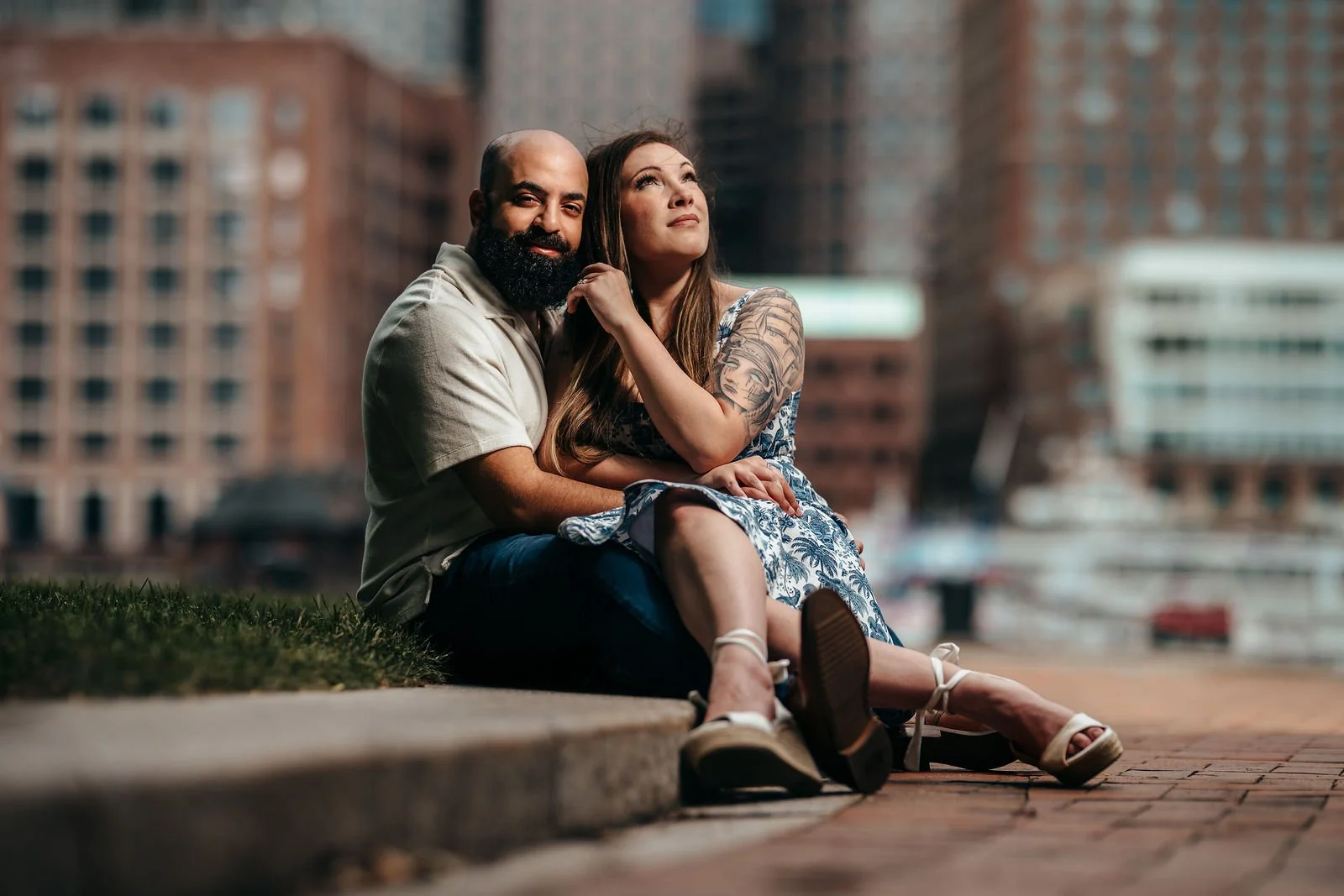 Couple sitting together overlooking the water in Seaport Boston