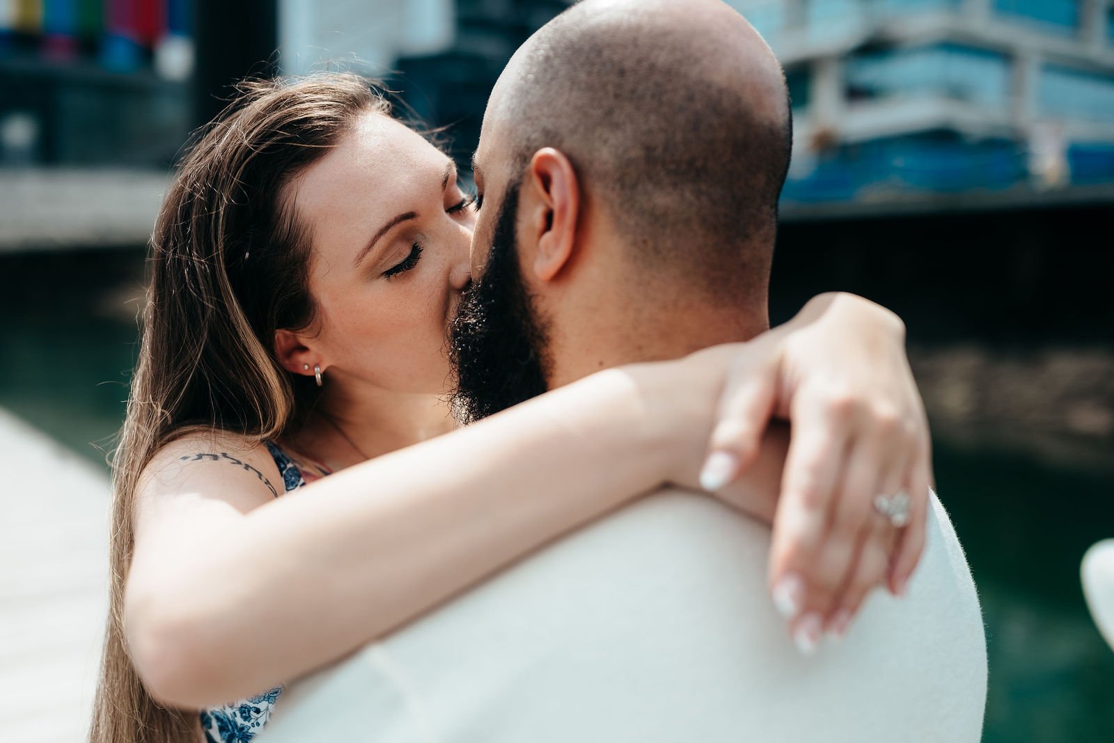 Close romantic moment between Aziz and Katherine, Seaport Boston engagement photos