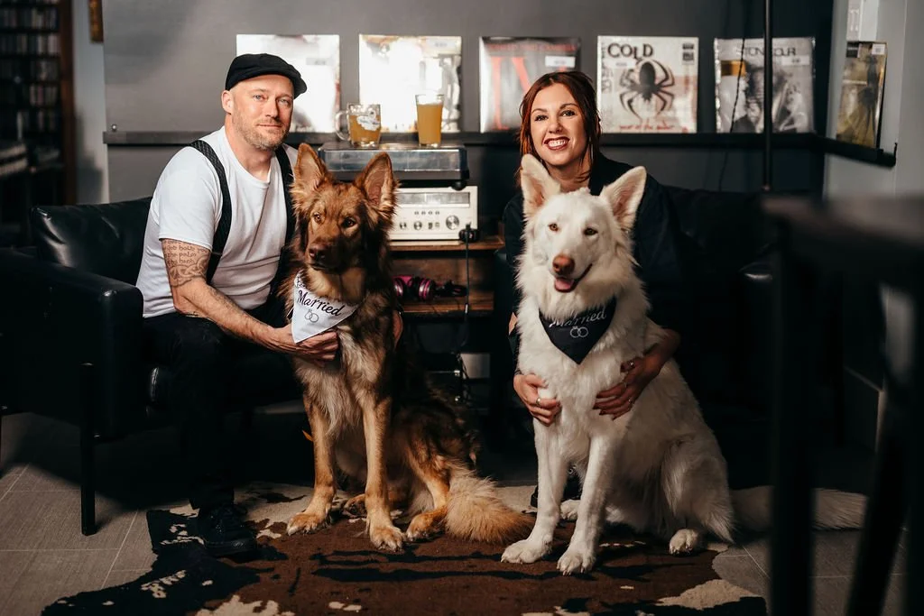 Kristin and Mike with their two dogs wearing Married bandanas, engagement session in Laconia