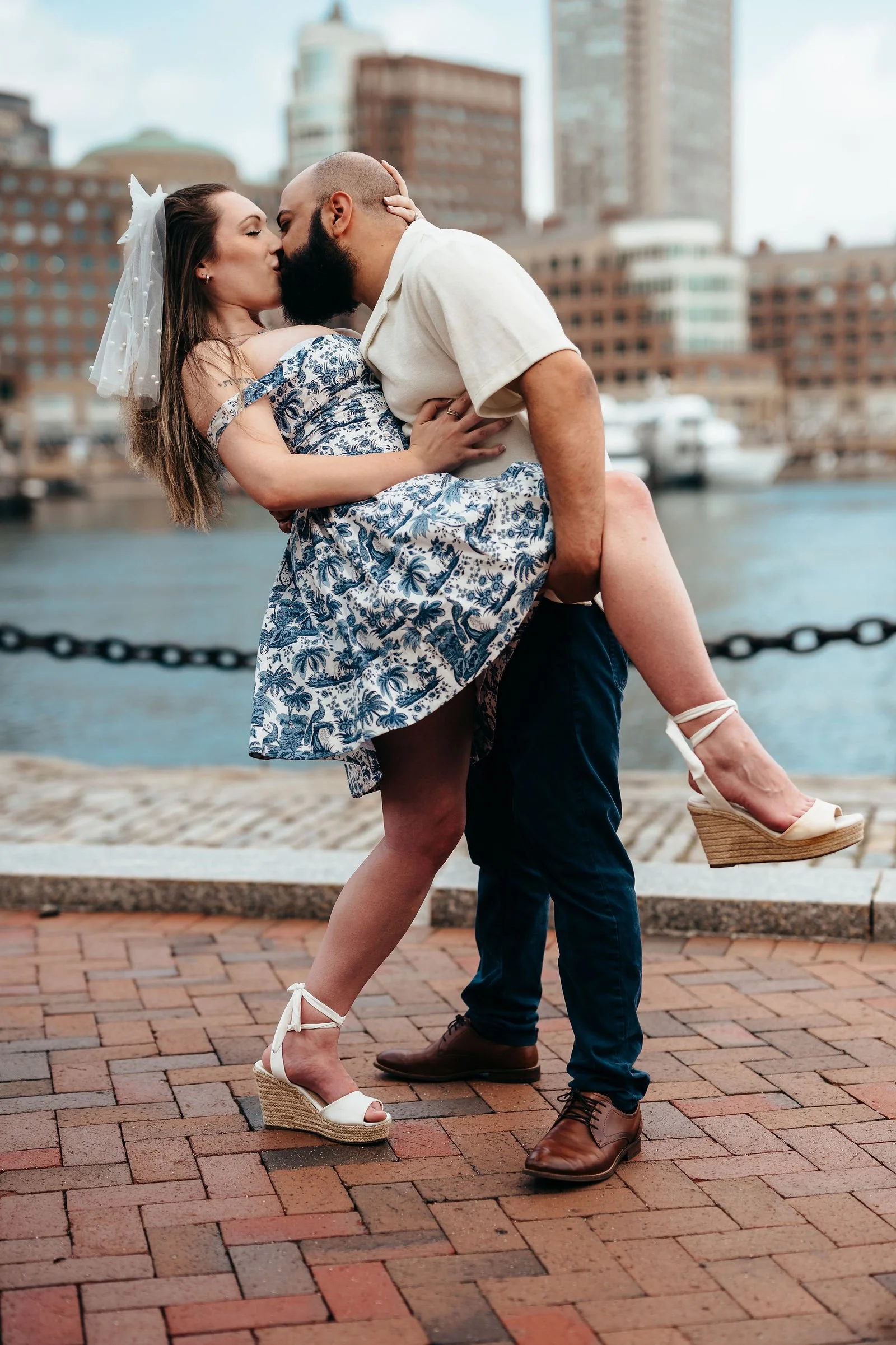 Aziz lifting Katherine on the Seaport waterfront, Boston engagement photos