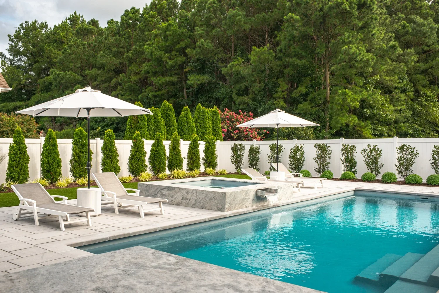 Custom luxury pool with spa and lounge seating