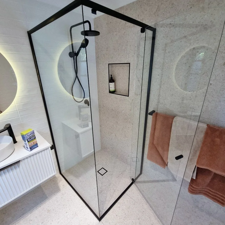 Semi-frameless shower screen installation in Sunshine Coast bathroom showing clean lines and minimal frame