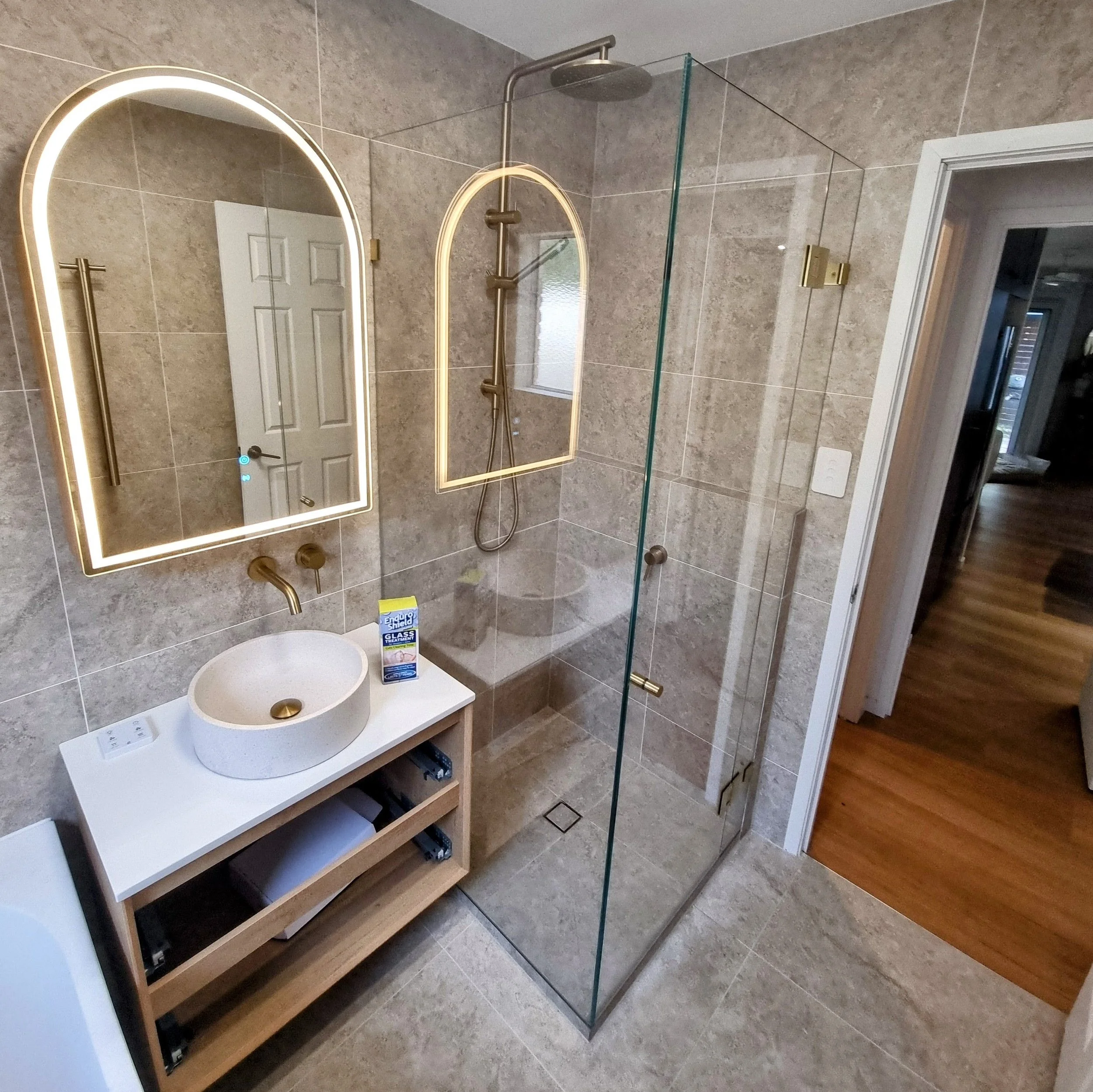 Frameless enclosed corner shower with low iron glass