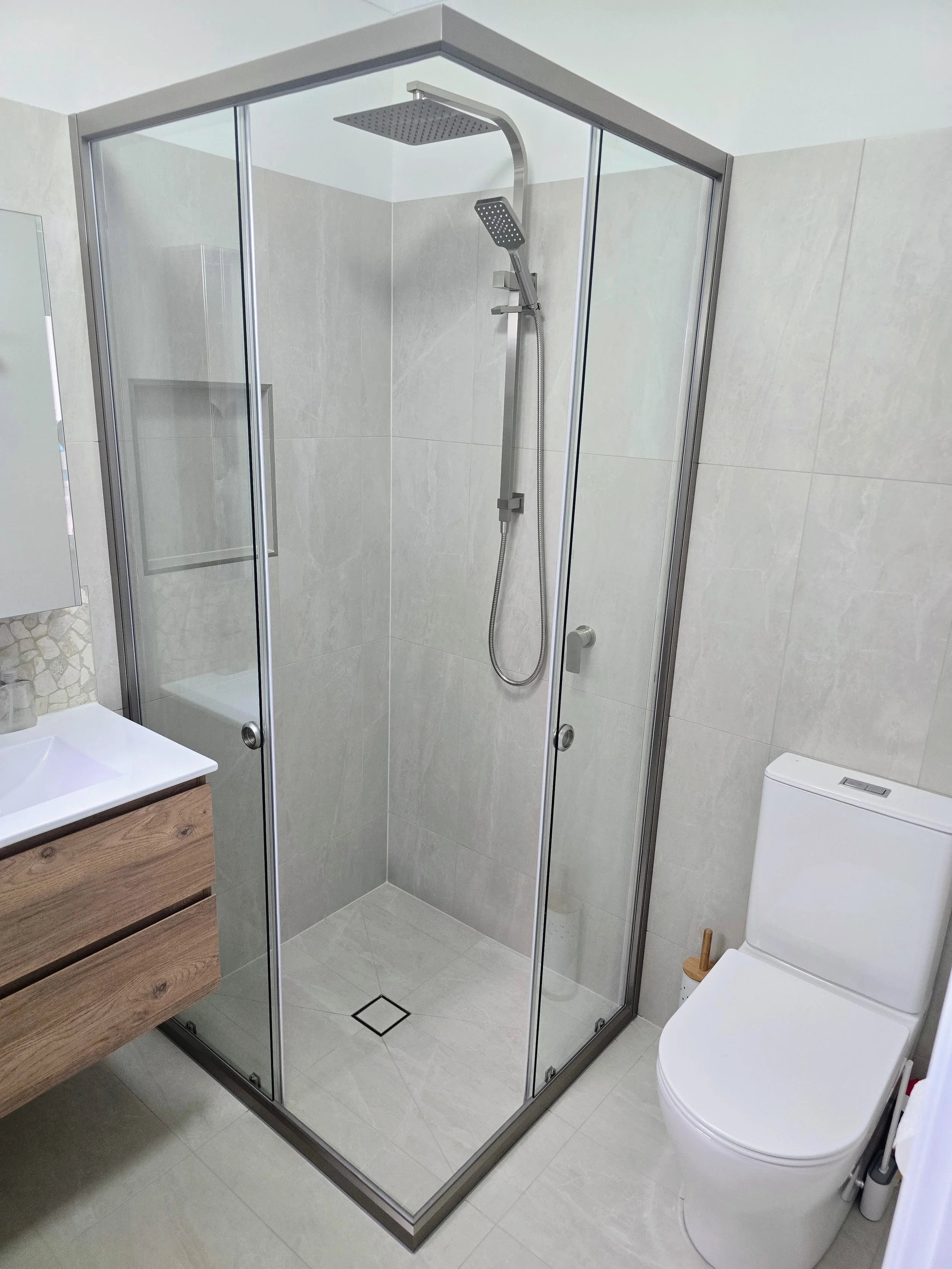Two door corner entry sliding shower screen with doors open