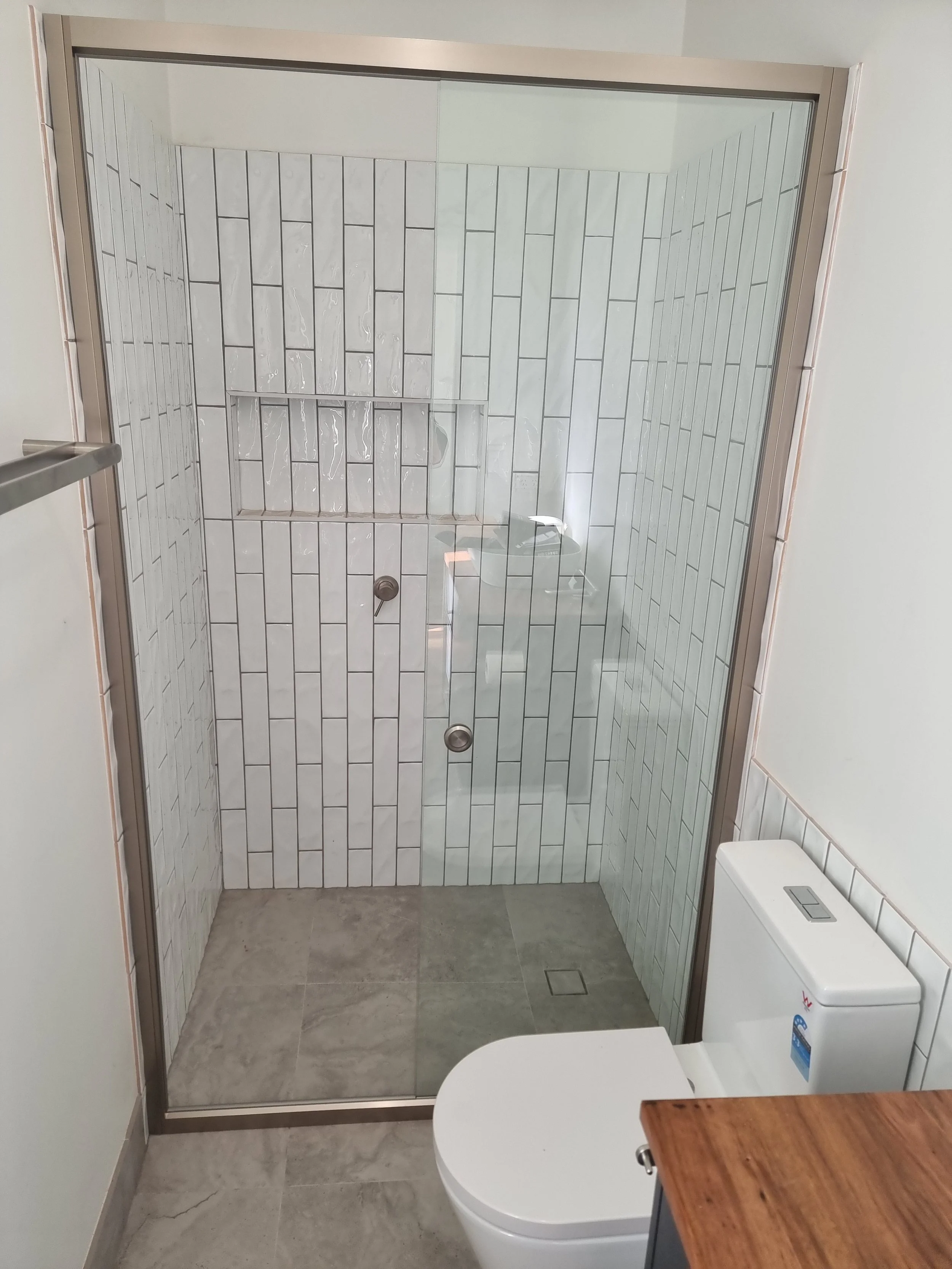 Semi-frameless slider in modern bathroom