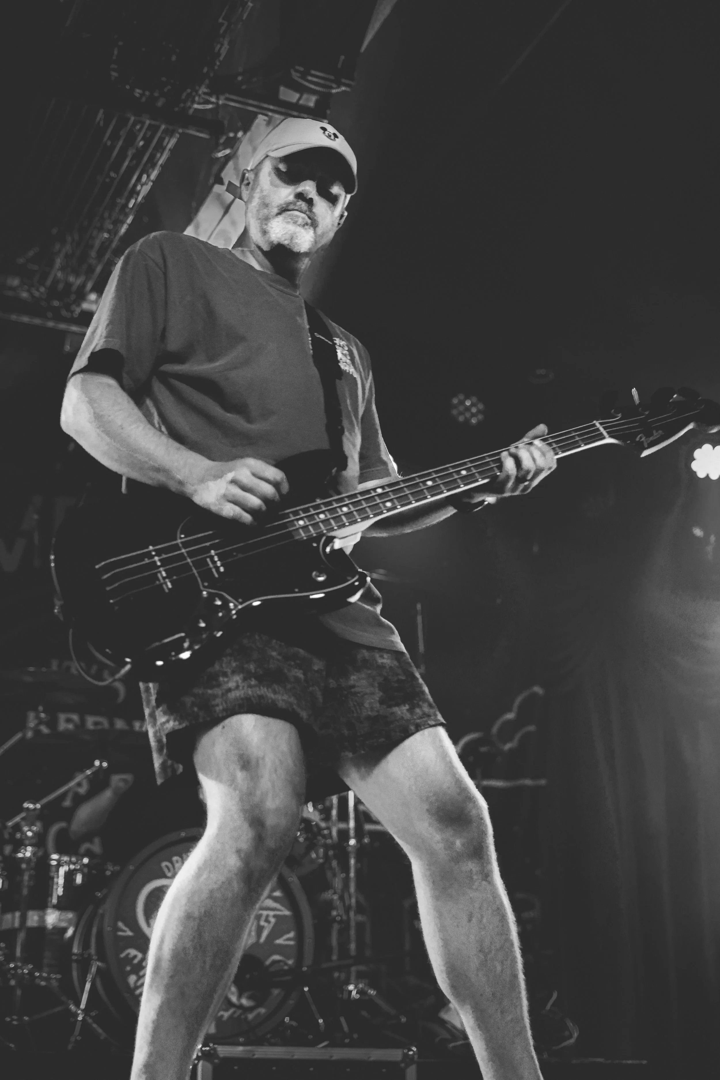 Driveways bassist performing in a beam of stage light during the Brooklyn Bowl show