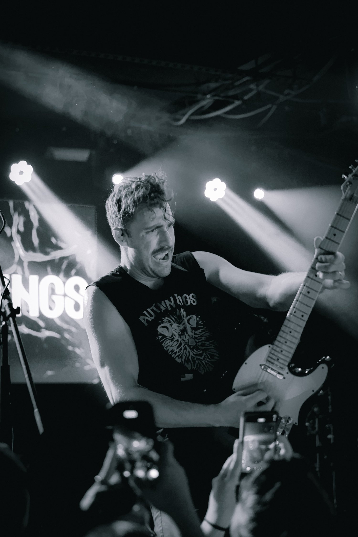 Autumn Kings band member performing during an energetic show
