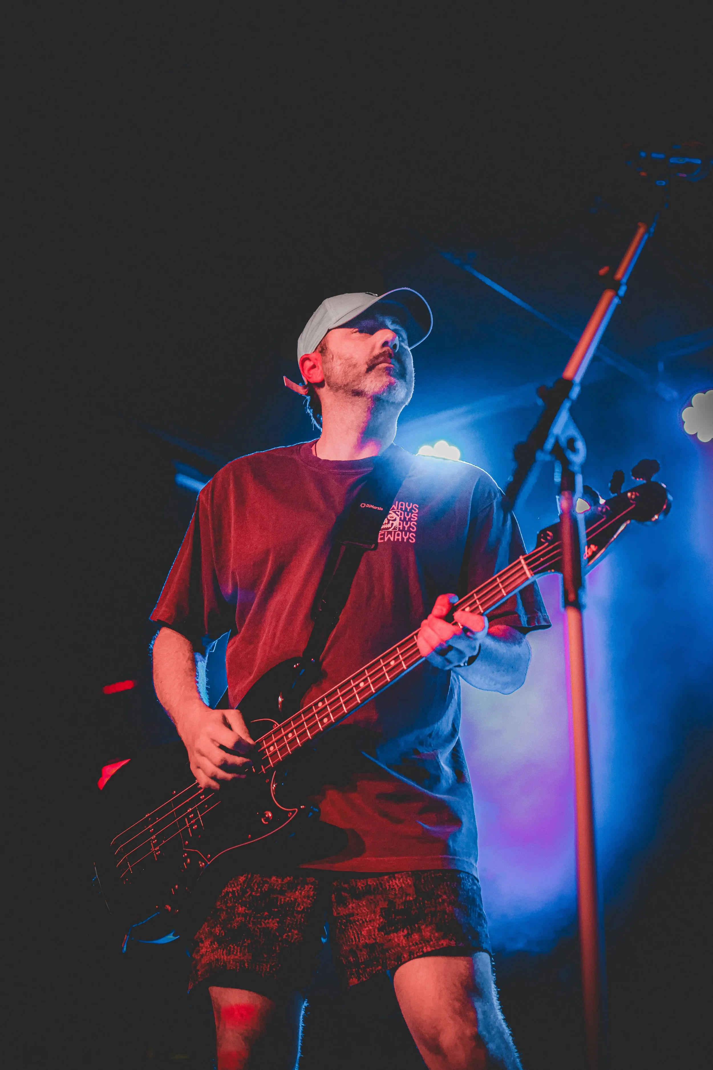 Driveways guitarist performing live under purple and blue stage lights at Brooklyn Bowl Philadelphia