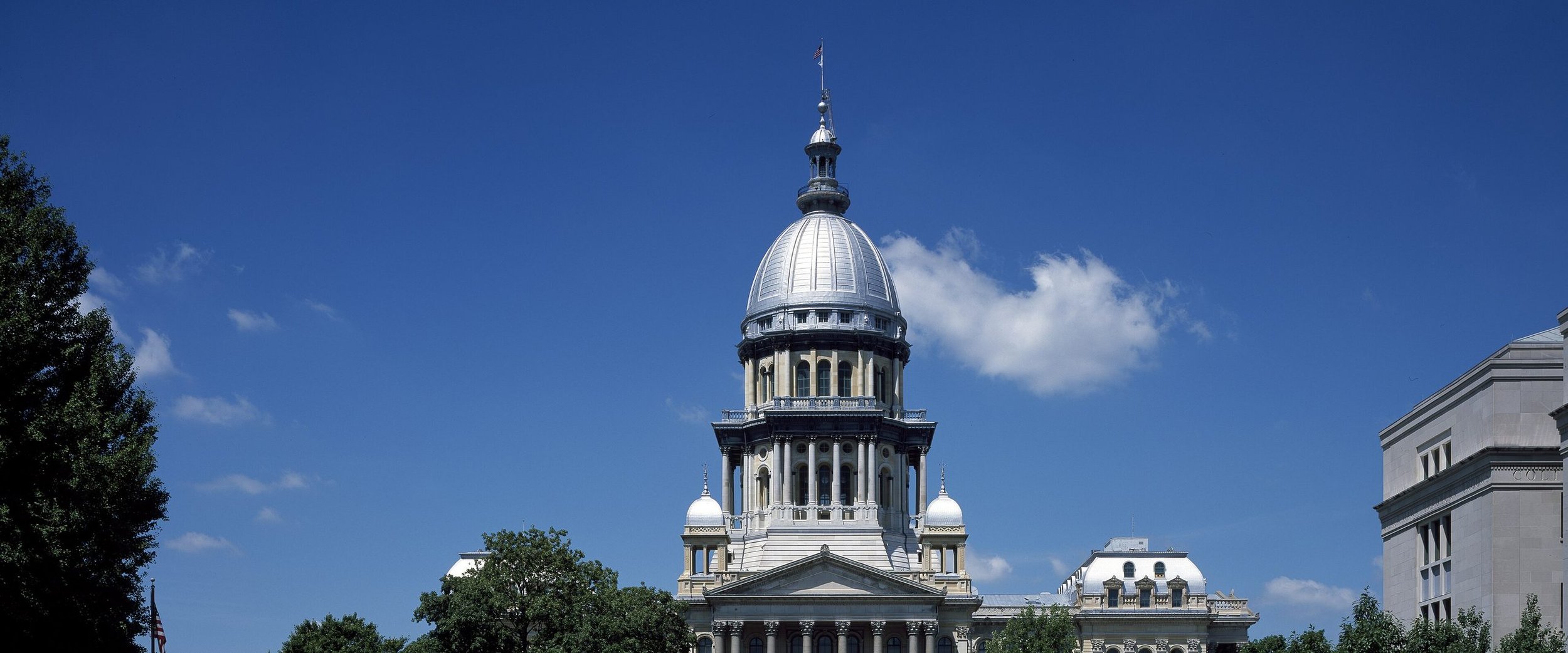 The dome of the Illinois State Capitol against a deep blue sky
