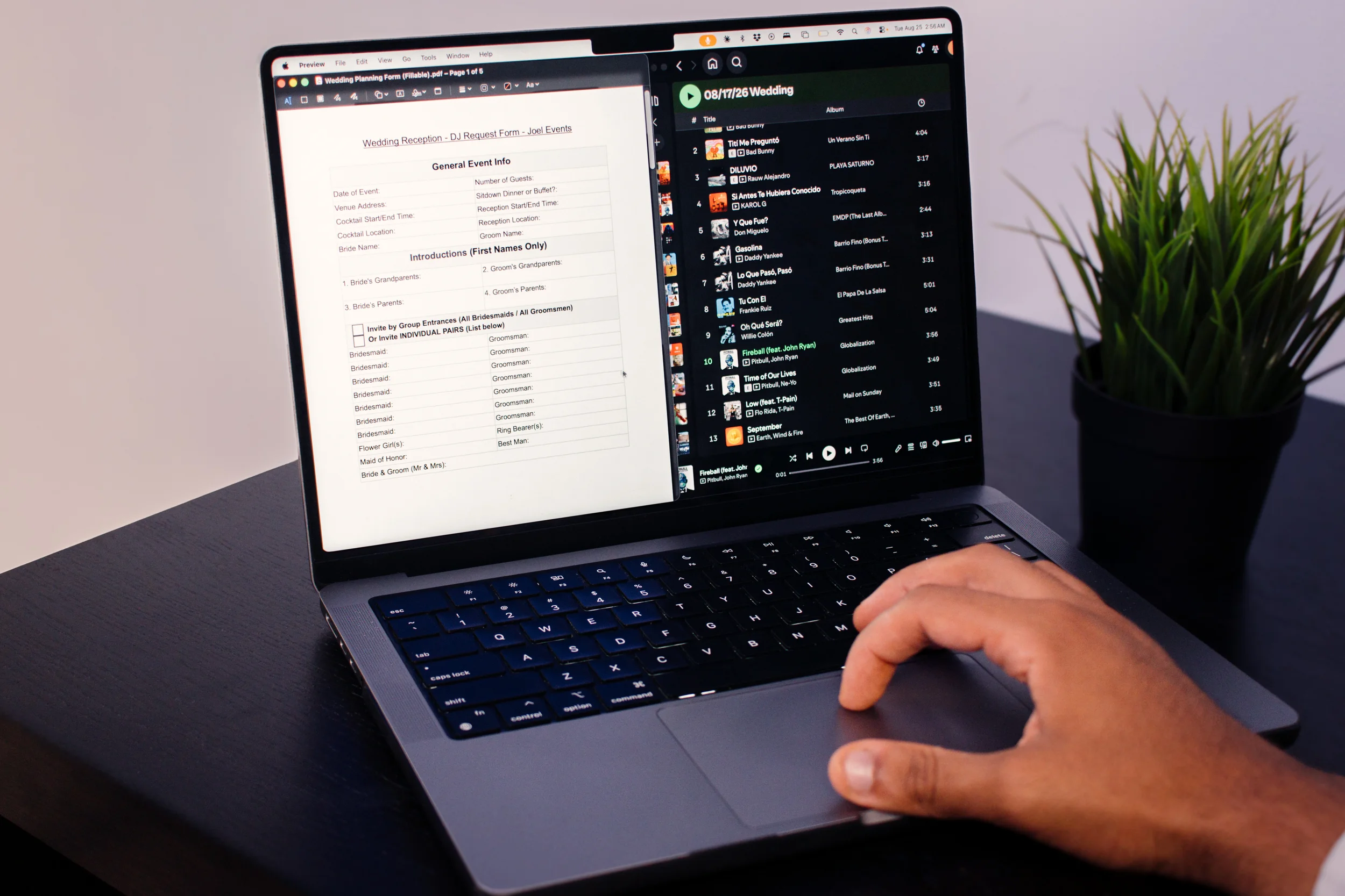 Laptop showing a personalized wedding music plan and reception timeline document