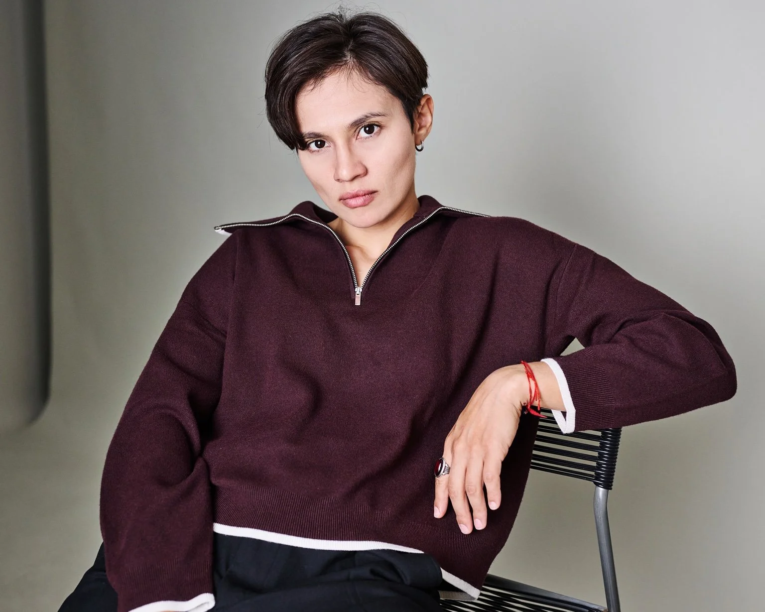 Ana Maria Ordoñez seated in a burgundy shirt, looking directly at the camera