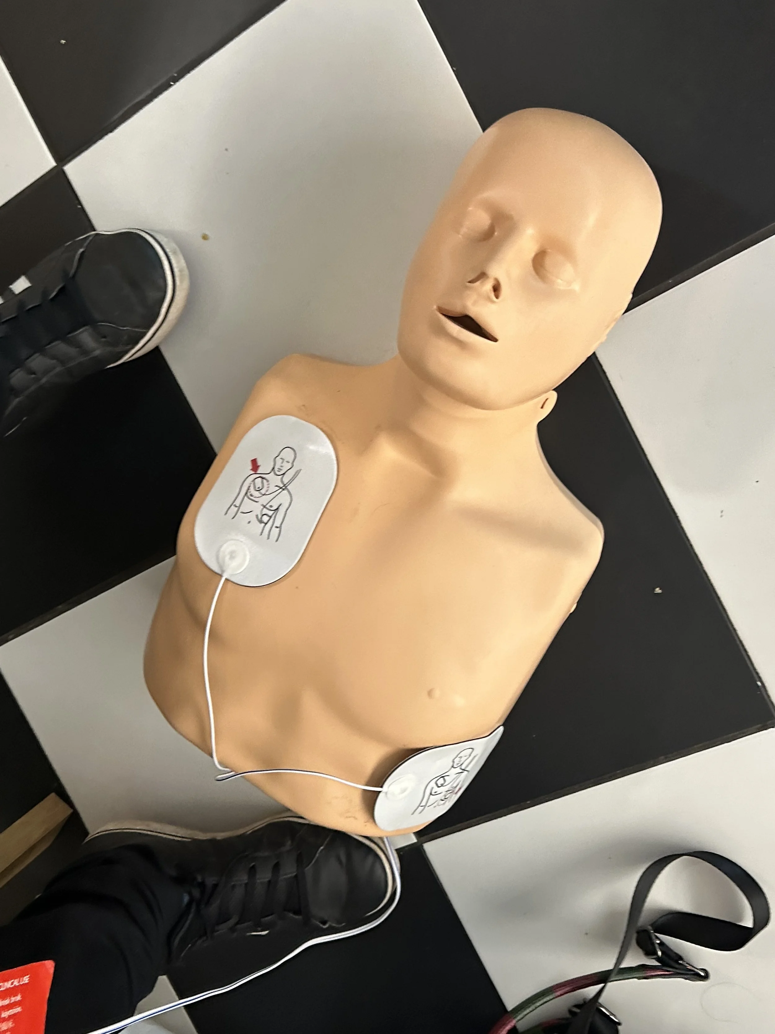 Hands using a defibrillator during CPR training
