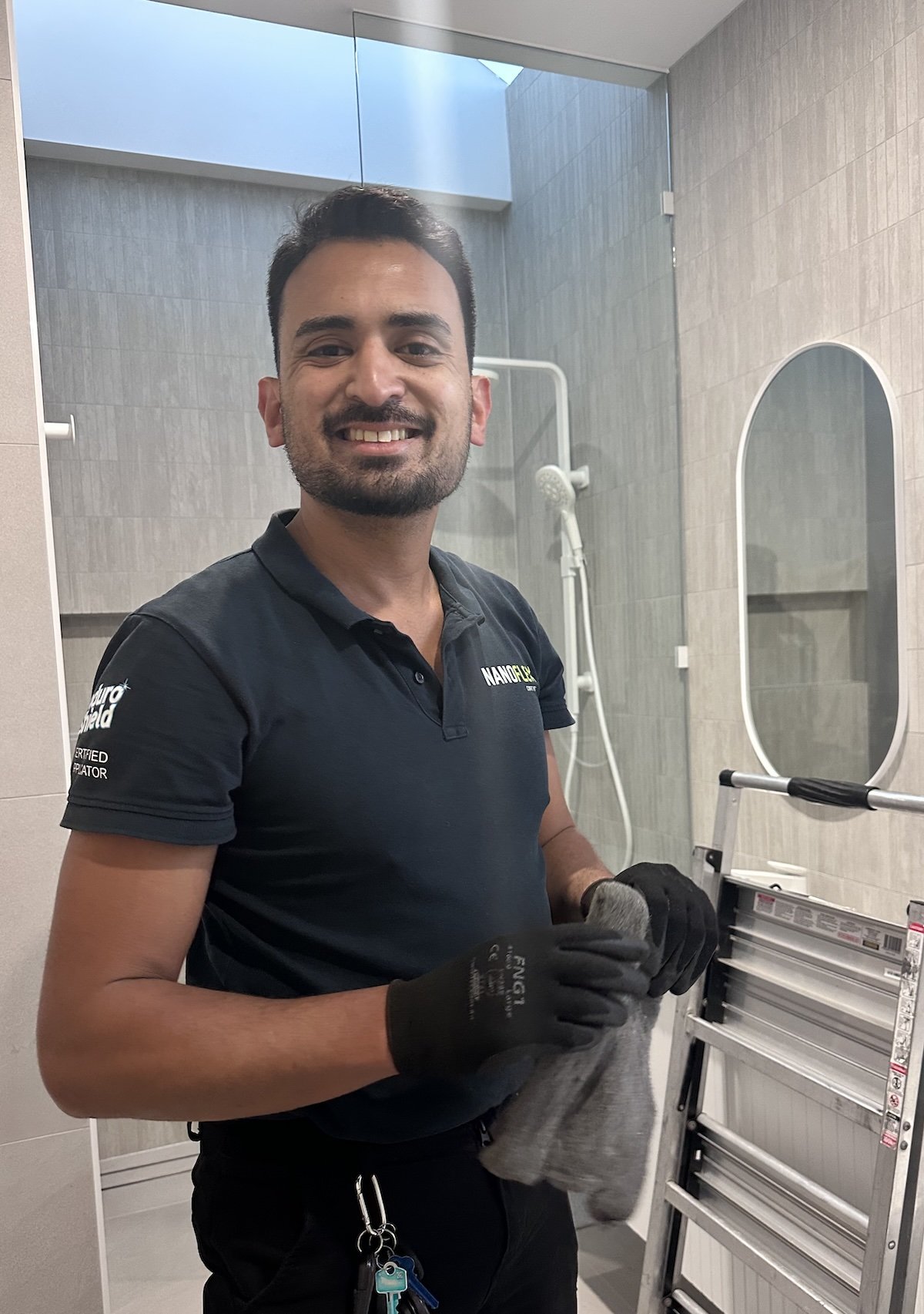 Amir, founder and owner of NanoFlex Coatings, preparing a Melbourne bathroom surface for professional treatment