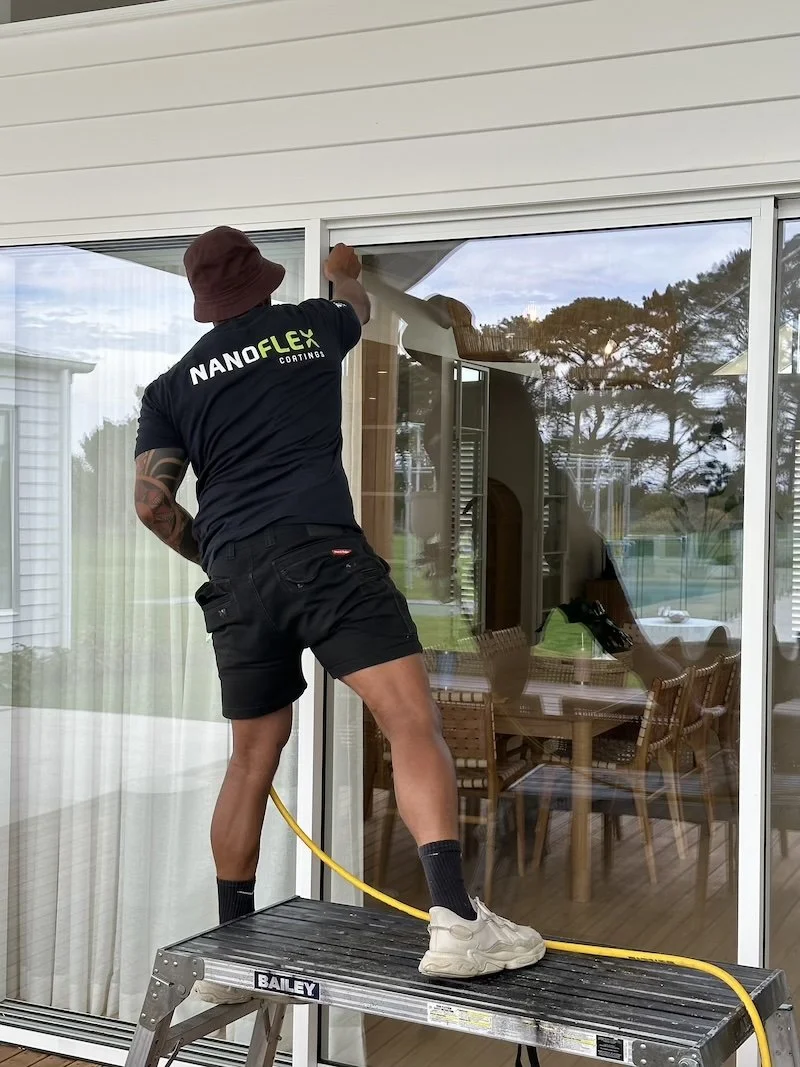 Melbourne home with large sliding glass doors, exterior windows and frameless glass balustrades