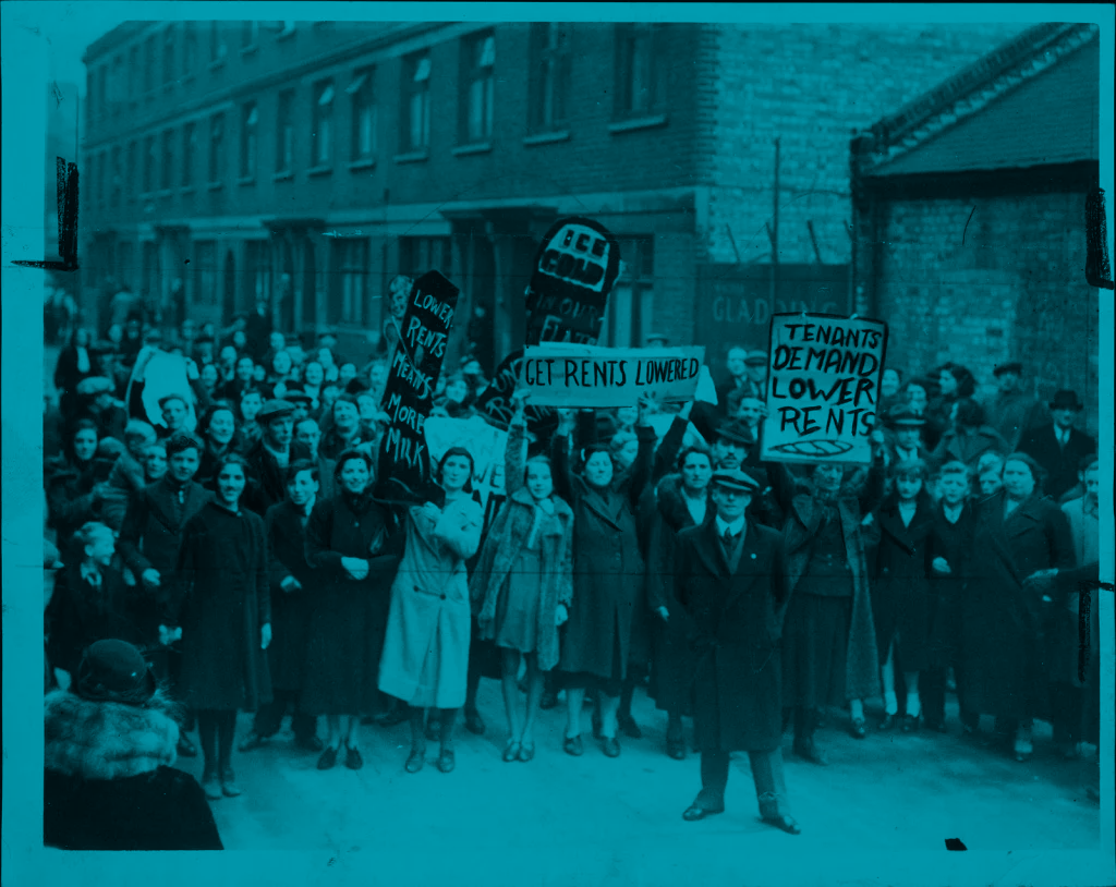 Period photograph from the 1939 Stepney Tenants' Defence League rent strike showing tenants organised on the street outside a housing block