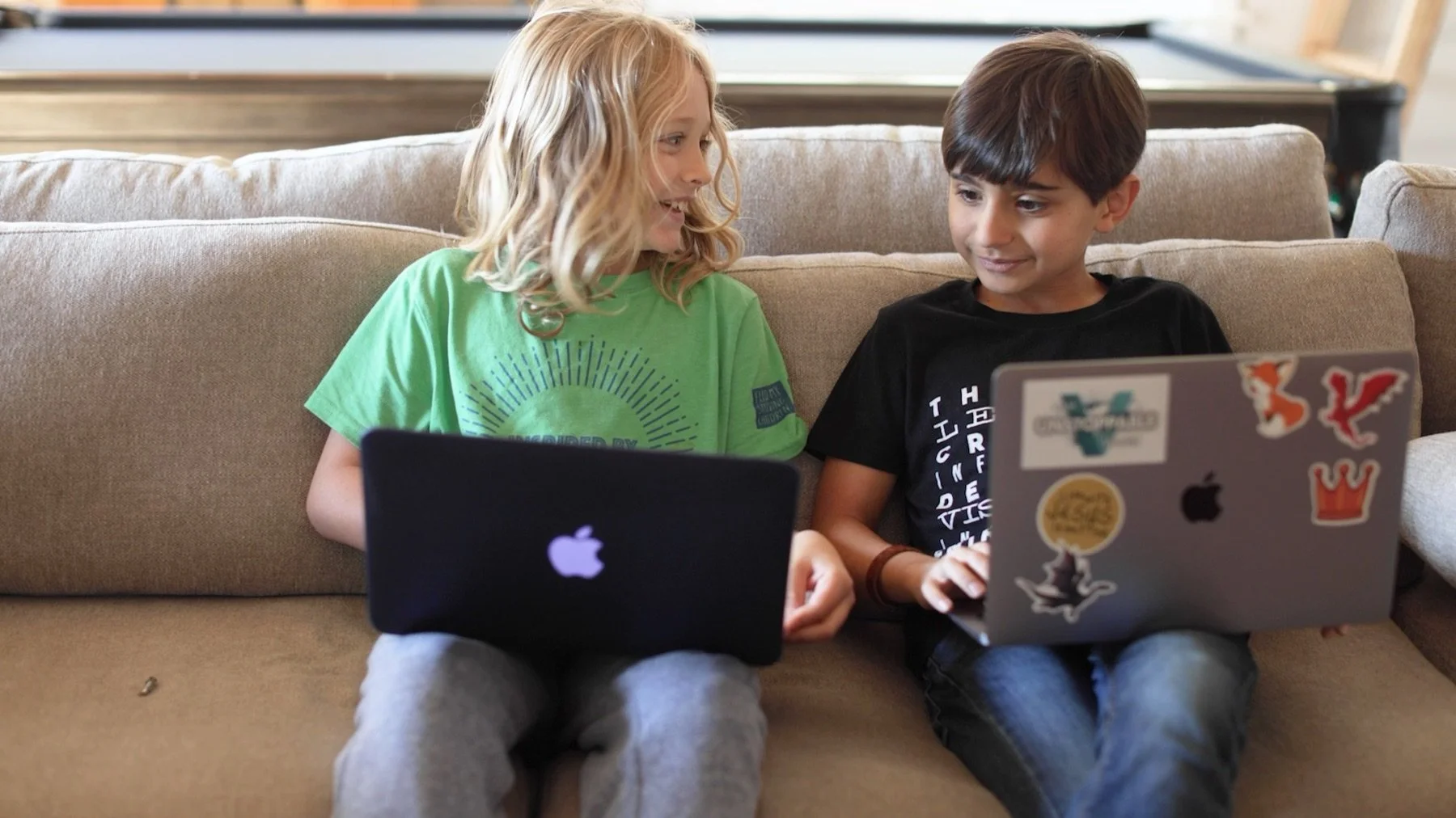 Two Valor students learning together on laptops from home