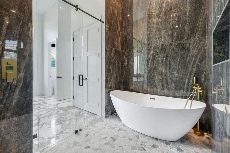 Primary bath with a freestanding tub and walk-in shower.