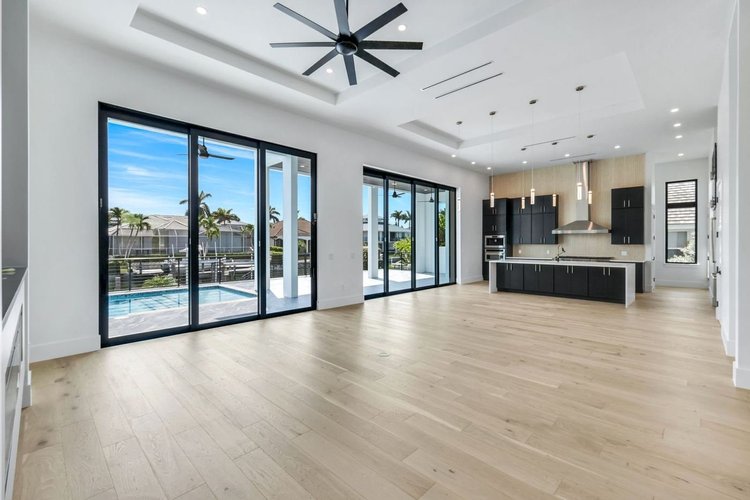 The great room opens to the lanai and pool through 16-foot pocket sliders.