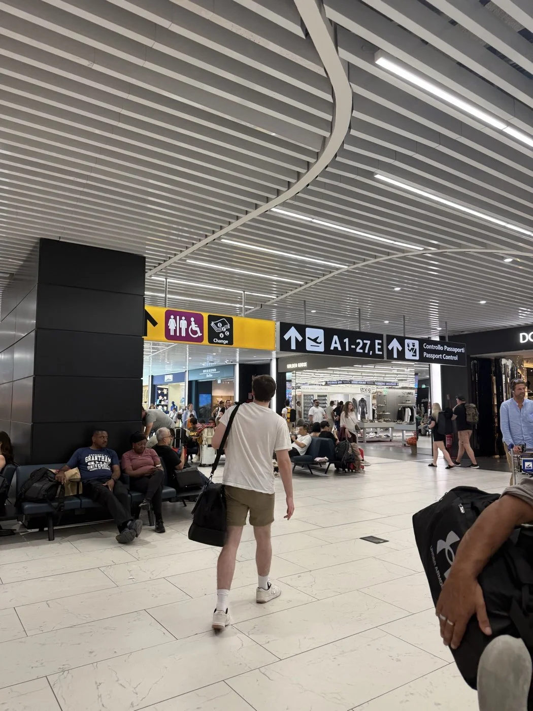 Luke walking fast through Fiumicino under the pictogram signs: the pictures pointed the way when the words could not