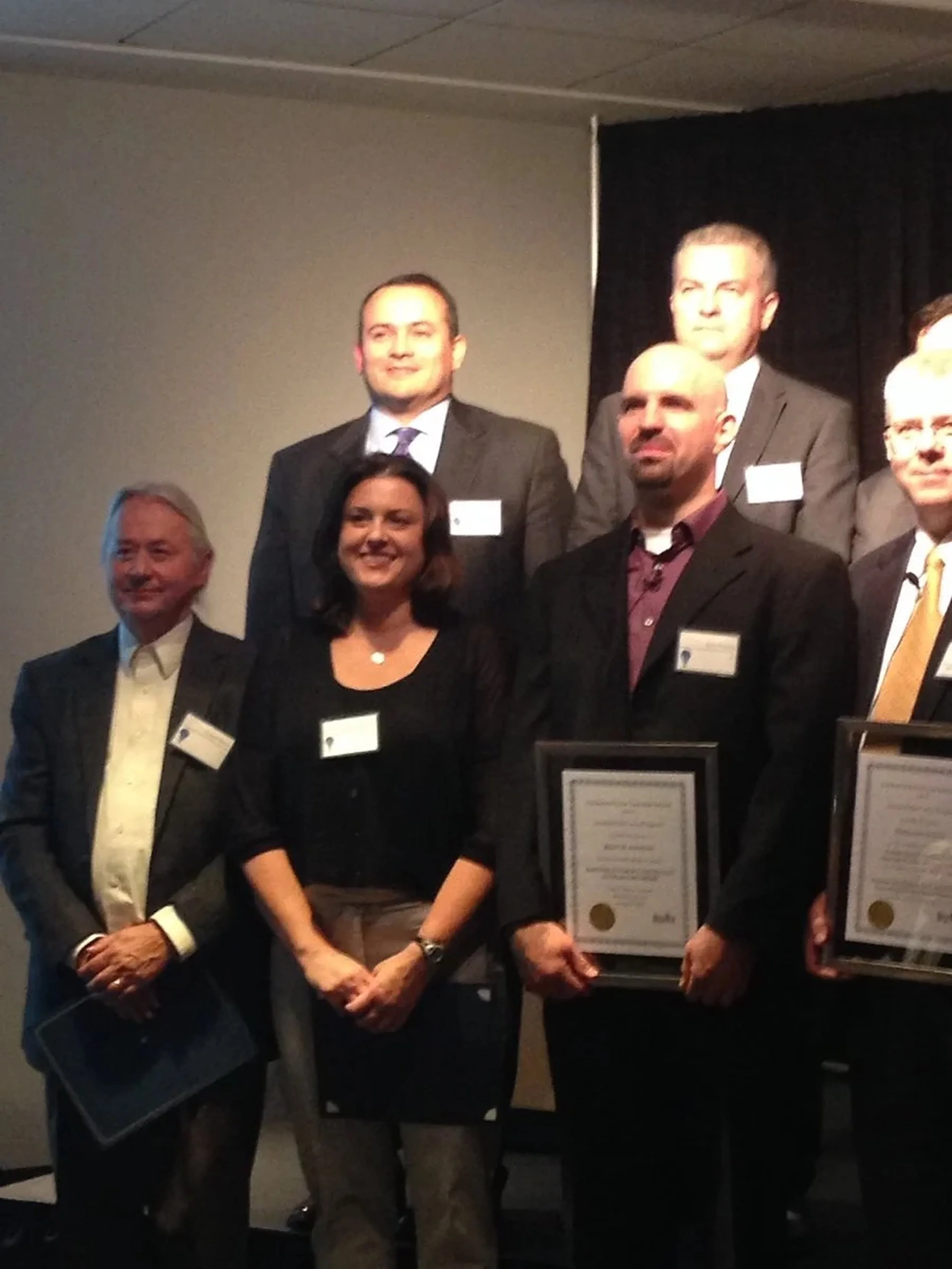 The Invented Here honorees on stage, Michele Walker front row
