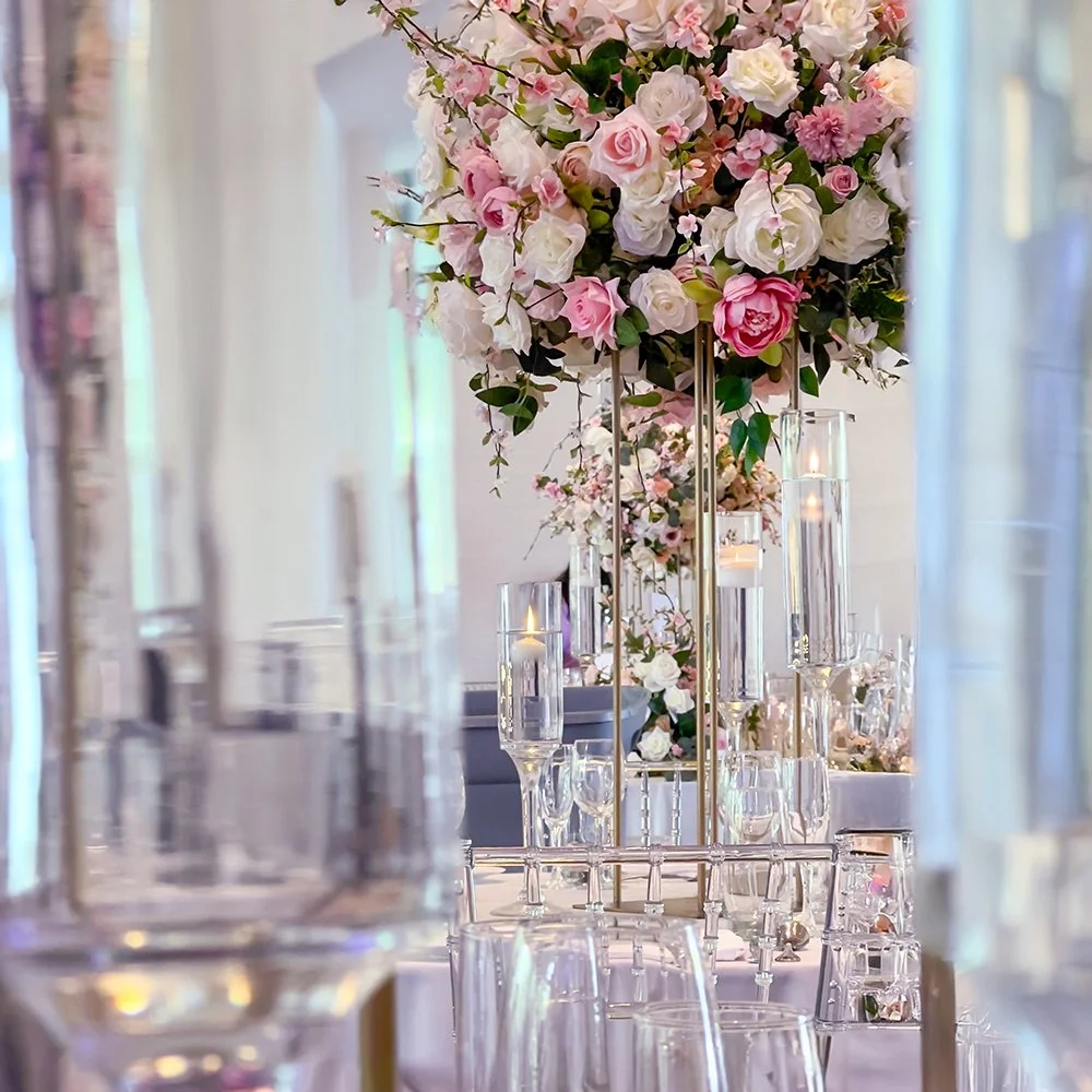 Luxury garden-inspired wedding centerpiece with blush roses, white flowers, delicate branches and greenery at The Guild Inn Toronto.