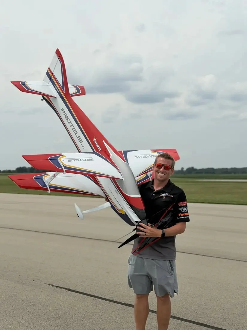 Andrew Jesky holding his Proteus F3A aircraft on the runway.