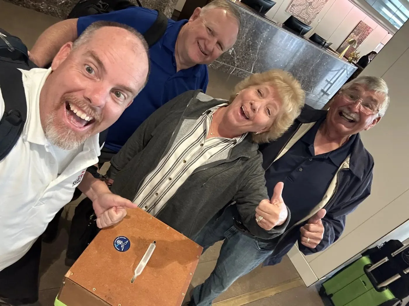 Tim Jesky giving a thumbs up in a team selfie with Joe Walker and friends.