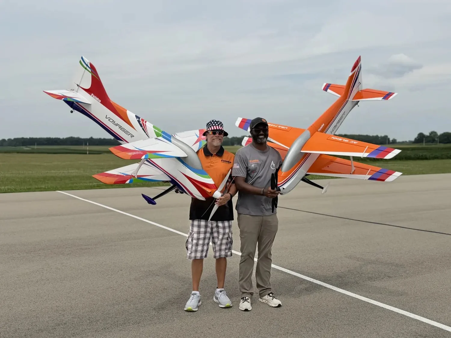 Jason Shulman and AC Glenn hold their Voyager F3A aircraft, showing the size of a 2-meter competition model.