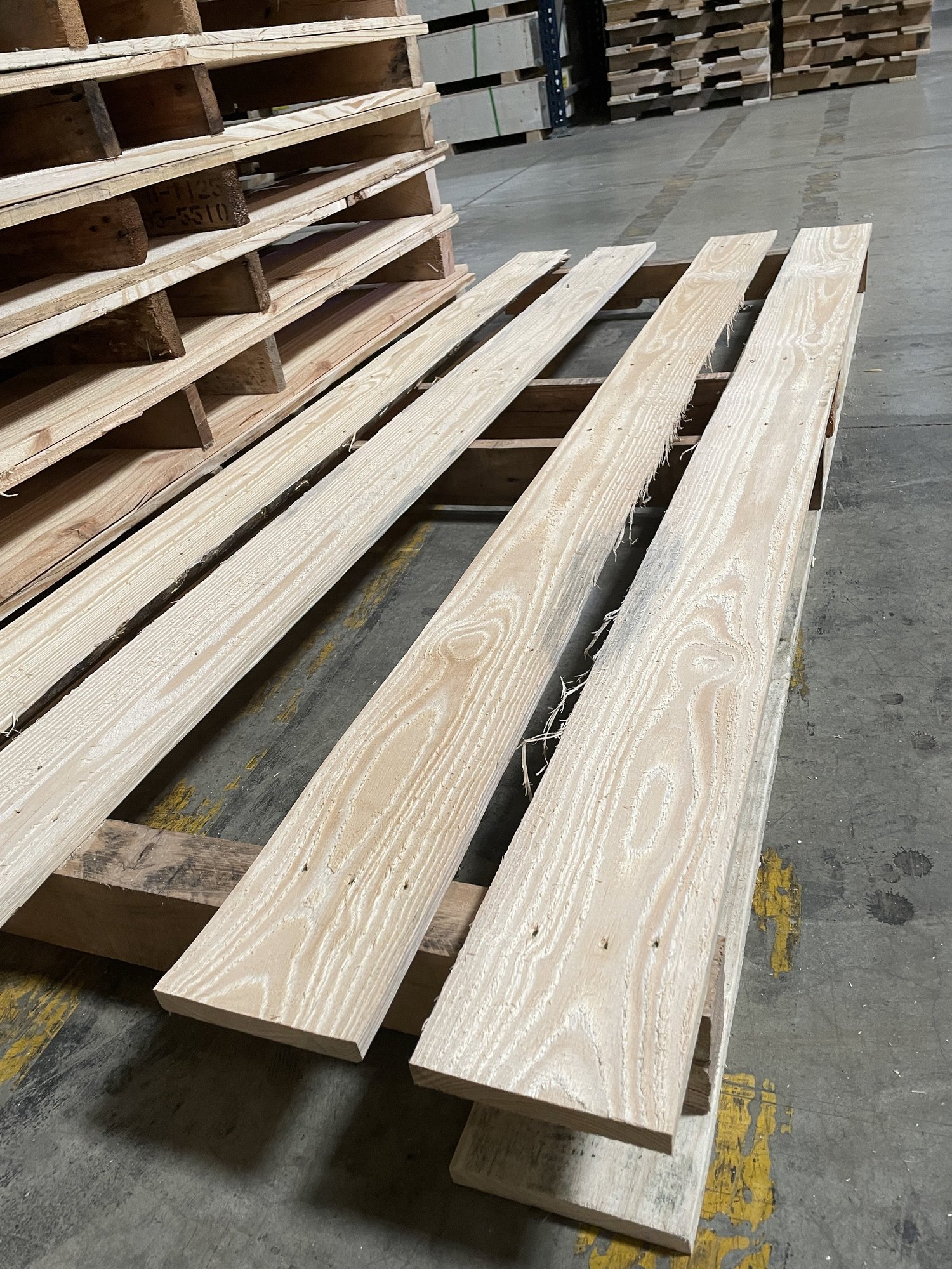 Side view of finished 30 by 78 custom pallets in the shop