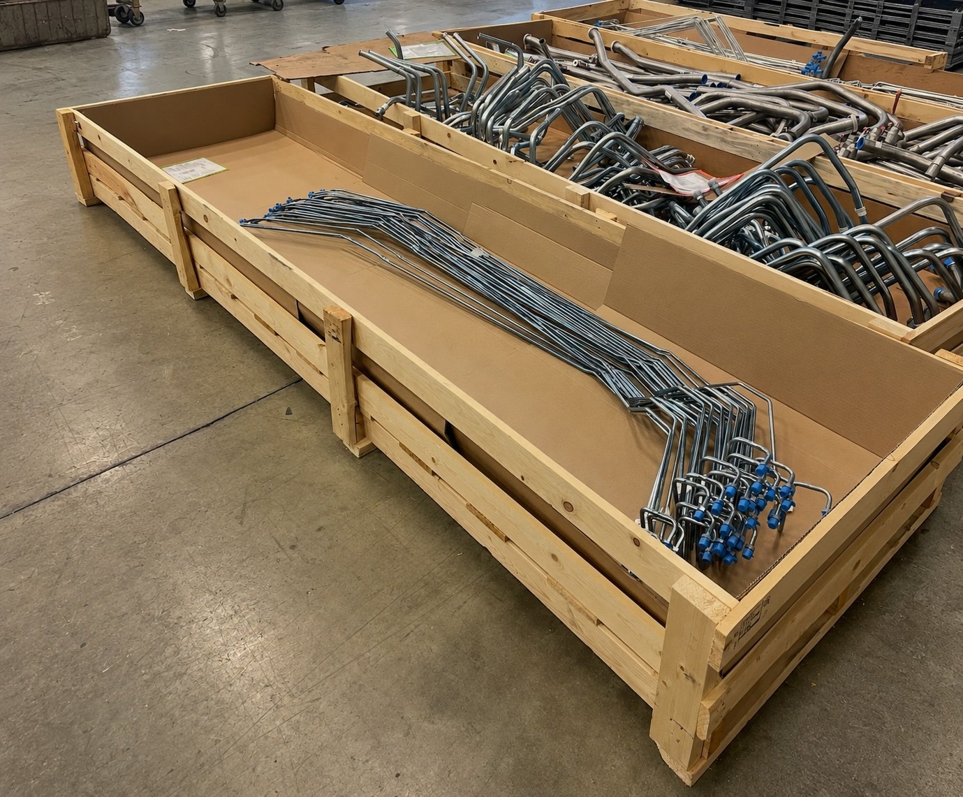 A long open-top Atlas crate loaded with formed steel tube product, lined and ready for the lid