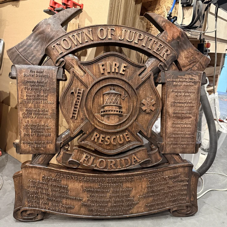Finished Town of Jupiter Fire Rescue custom wood plaque with crossed axes, lighthouse emblem and founding leadership names