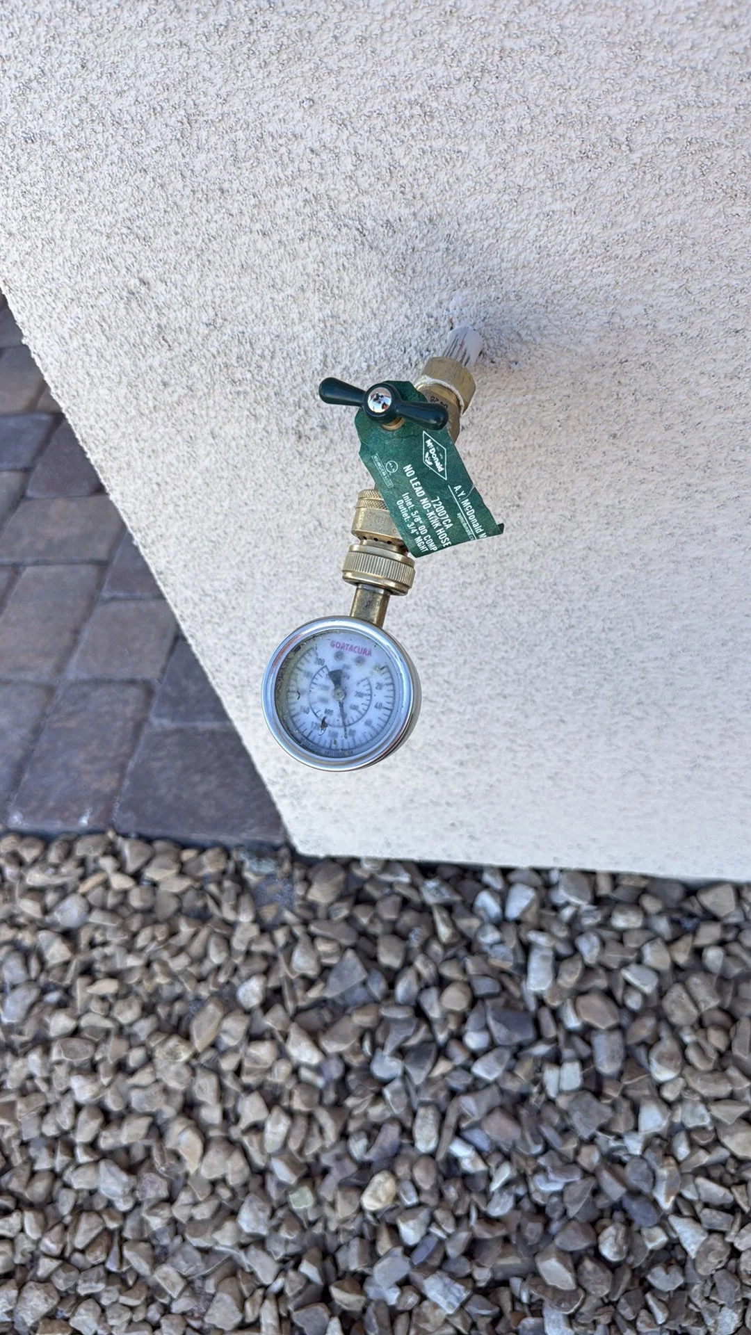Close-up of a water pressure gauge reading 85 PSI