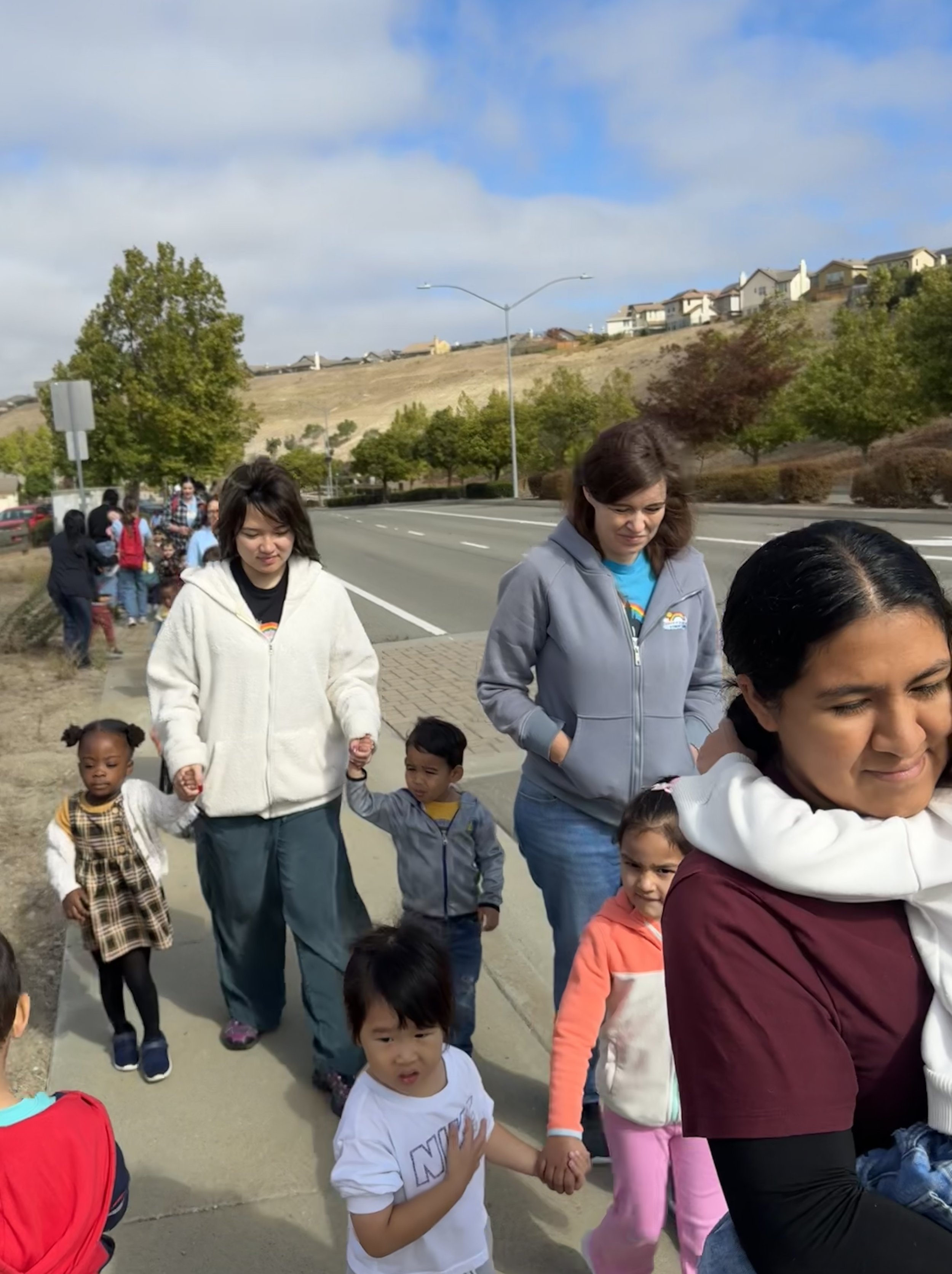 Educators walking hand in hand with children during the fire drill