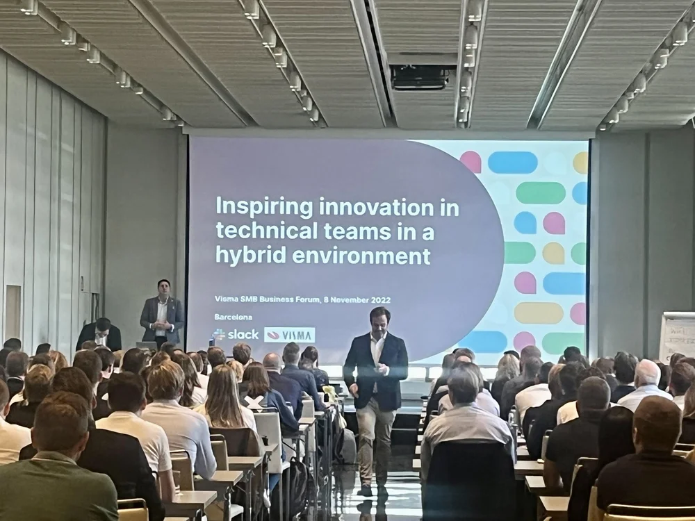 Karl Nicholson presenting to an audience beside a slide about innovation in technical teams