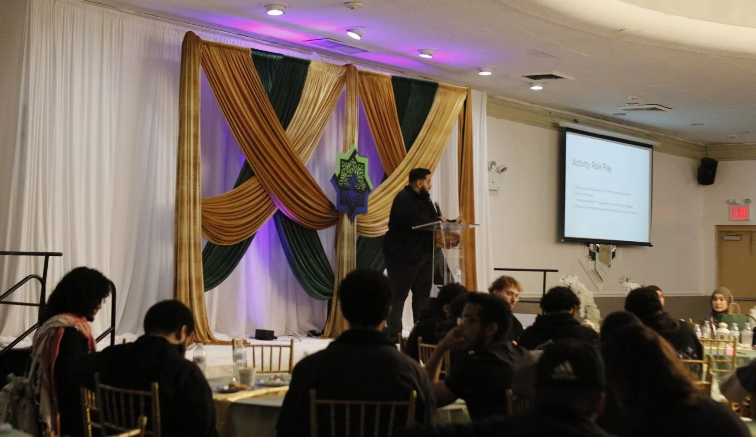 Student leaders at their tables facing the podium during a session