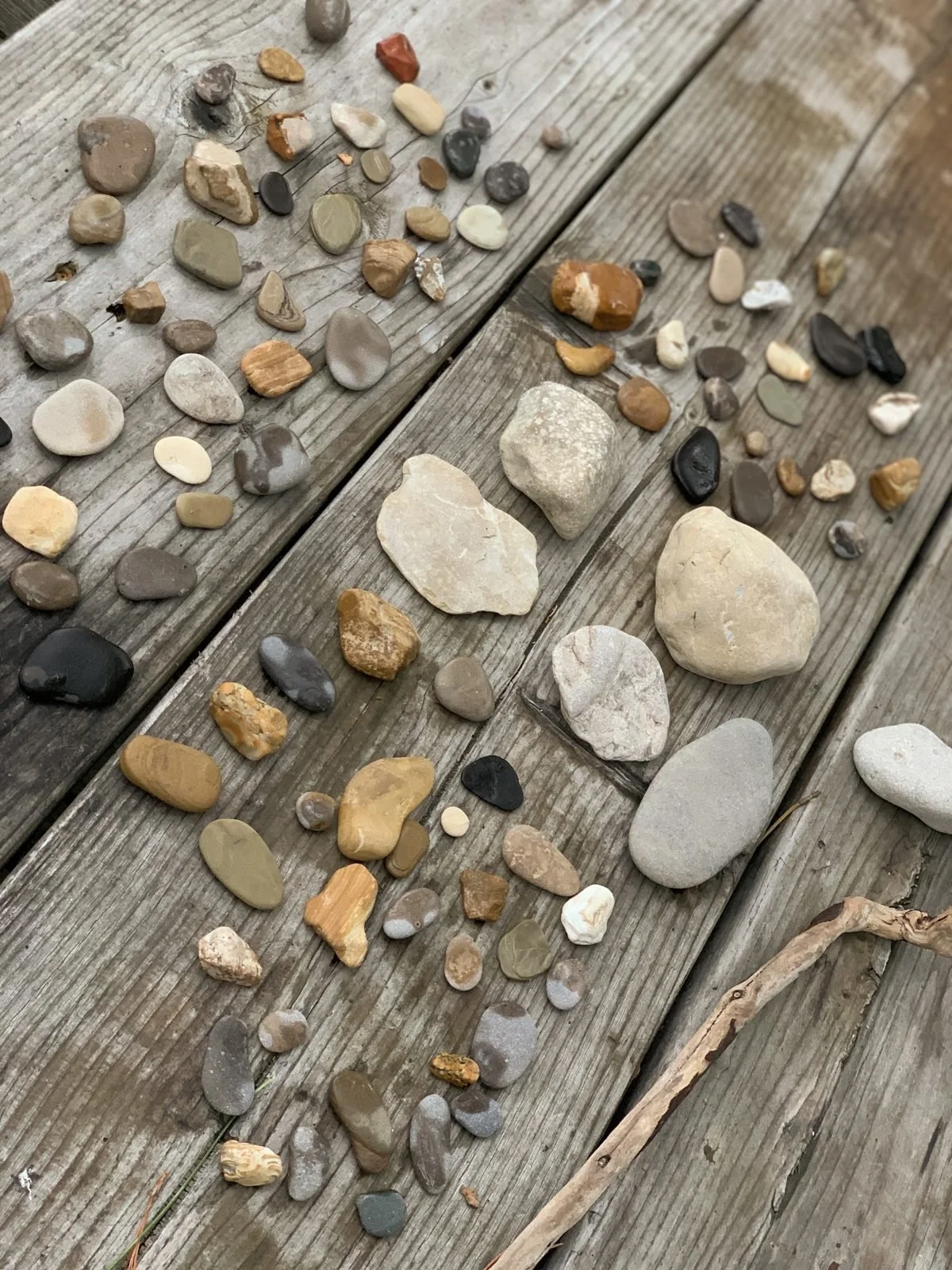 River stones sorted on a weathered wood table
