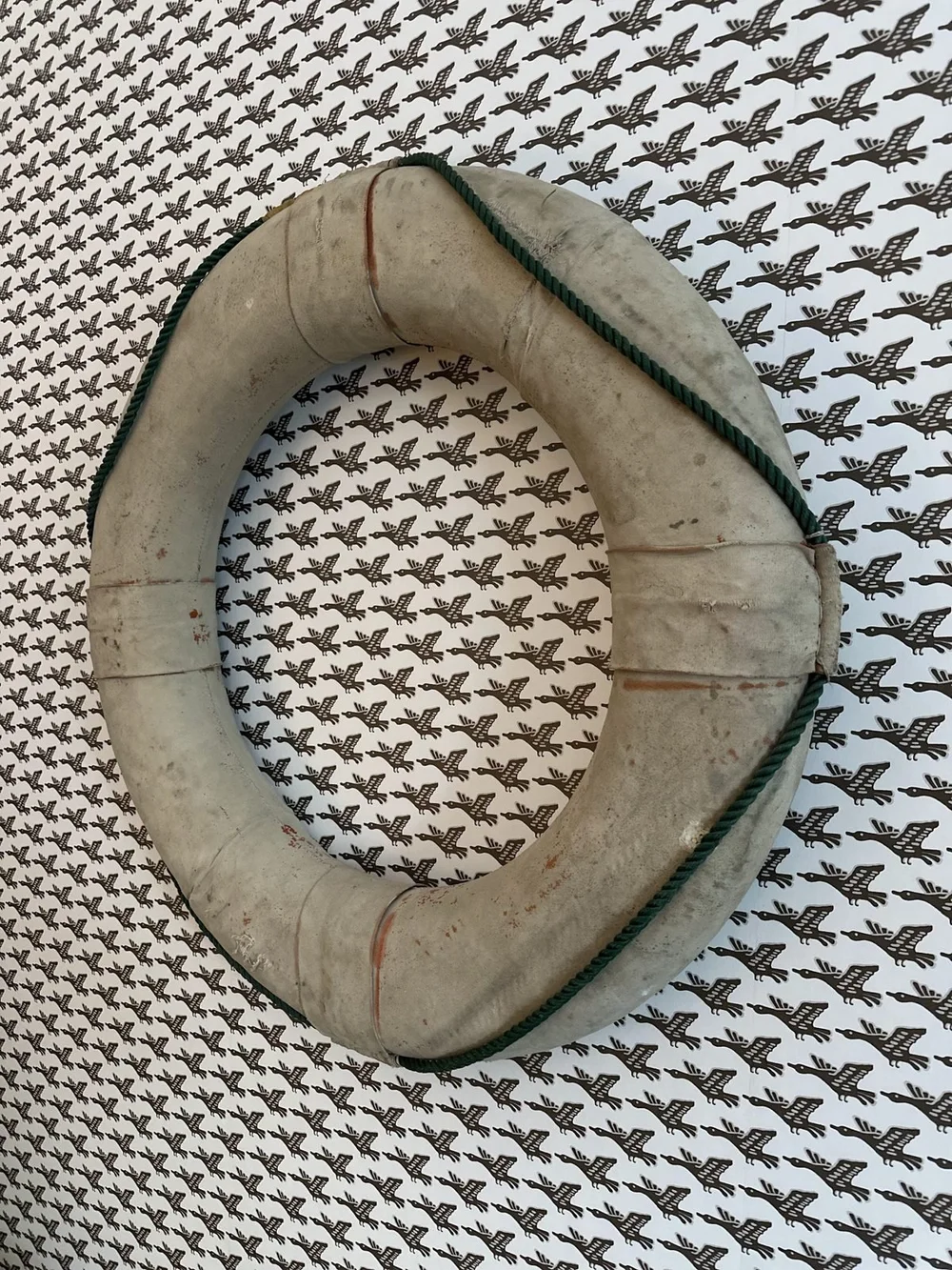 A worn wooden ring on a black and white patterned textile