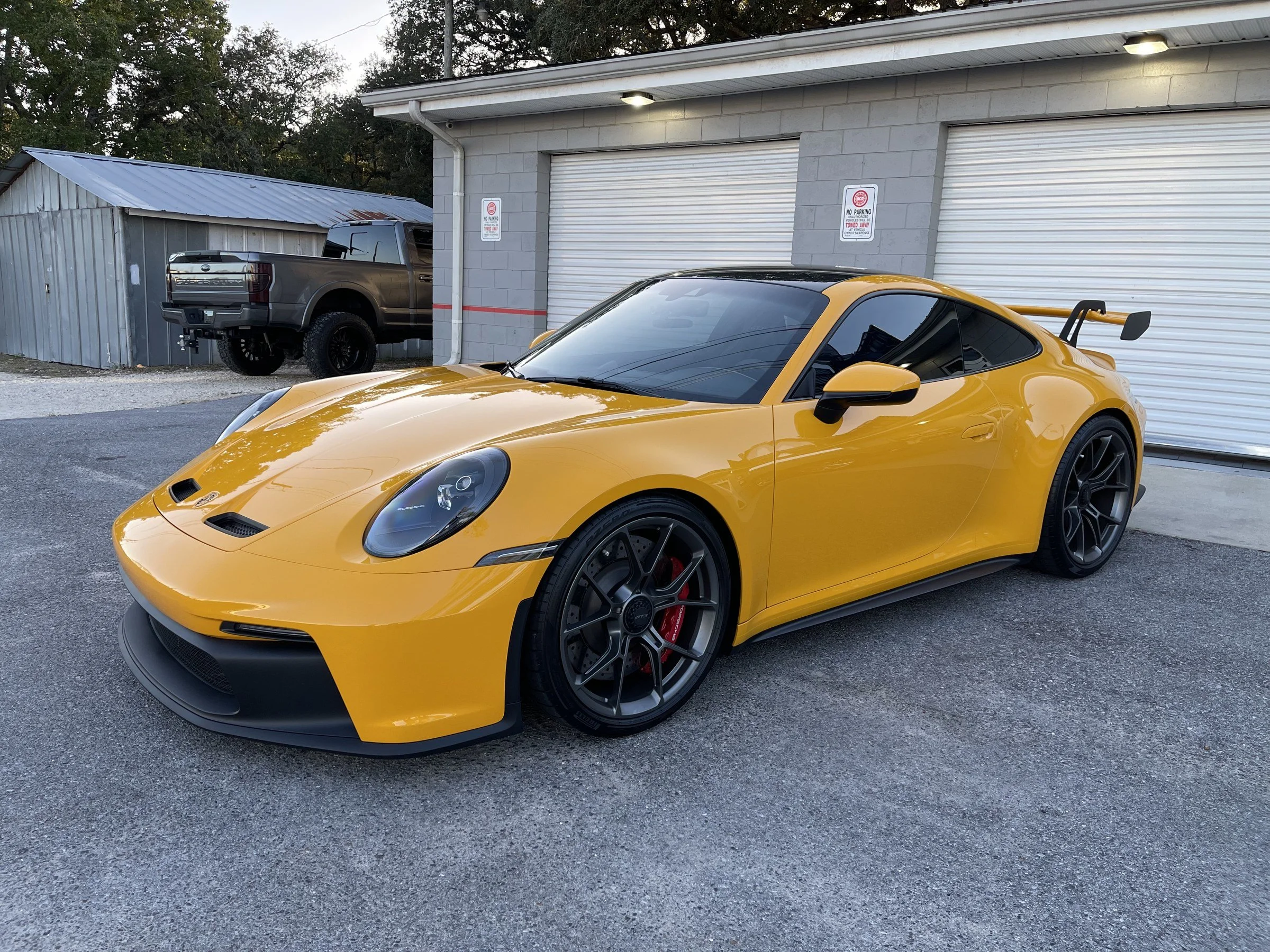 Yellow Porsche 911 GT3 outside the OCD shop