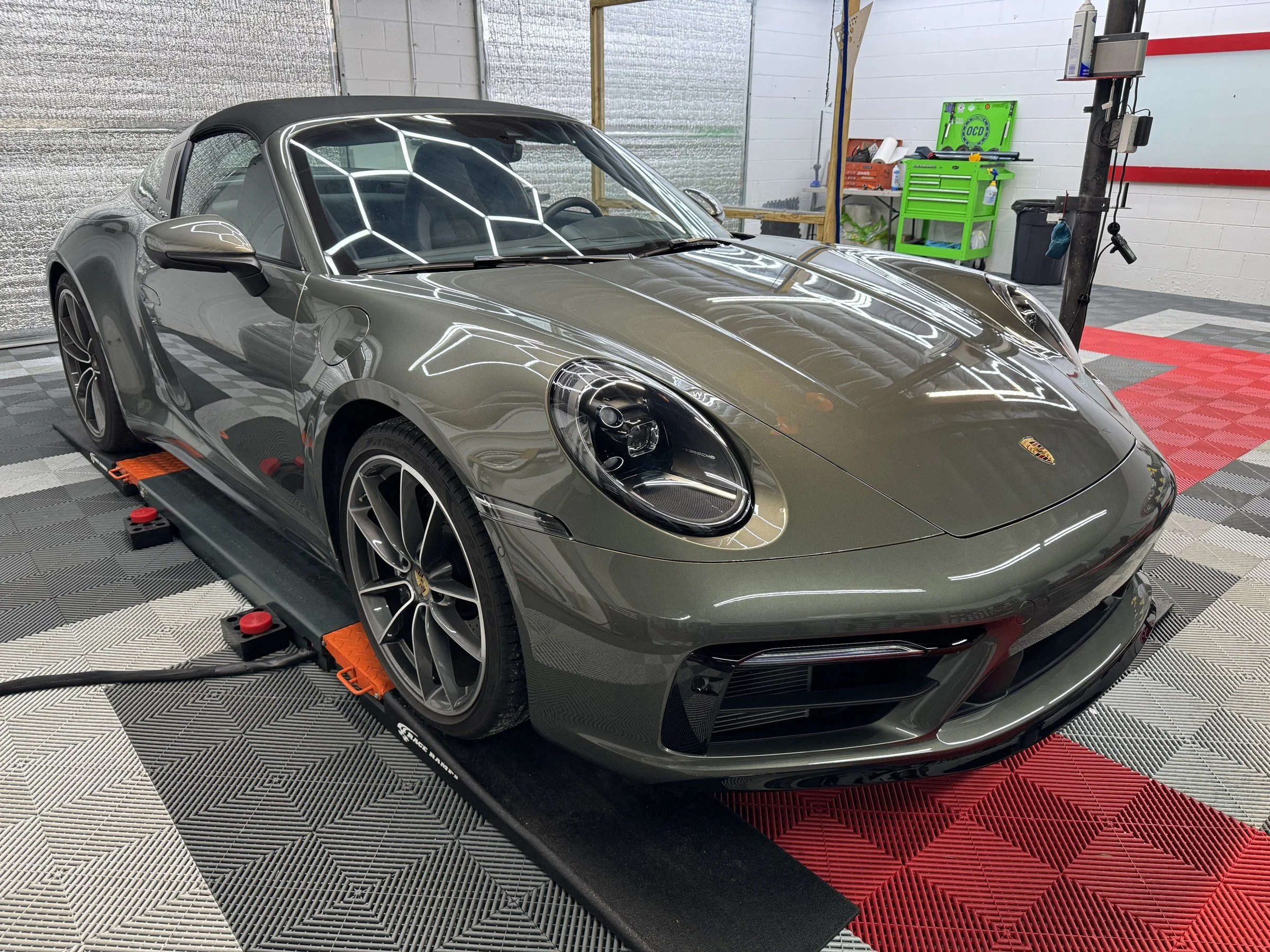 Gray Porsche 911 cabriolet inside the OCD installation bay