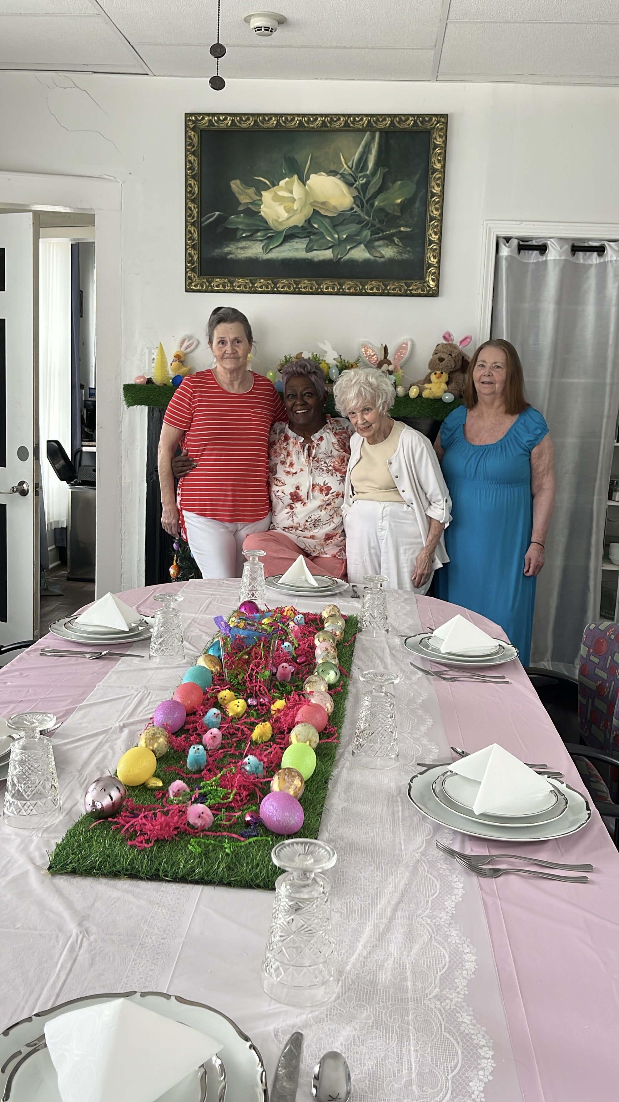 Seniors gathered around the beautifully set Easter table