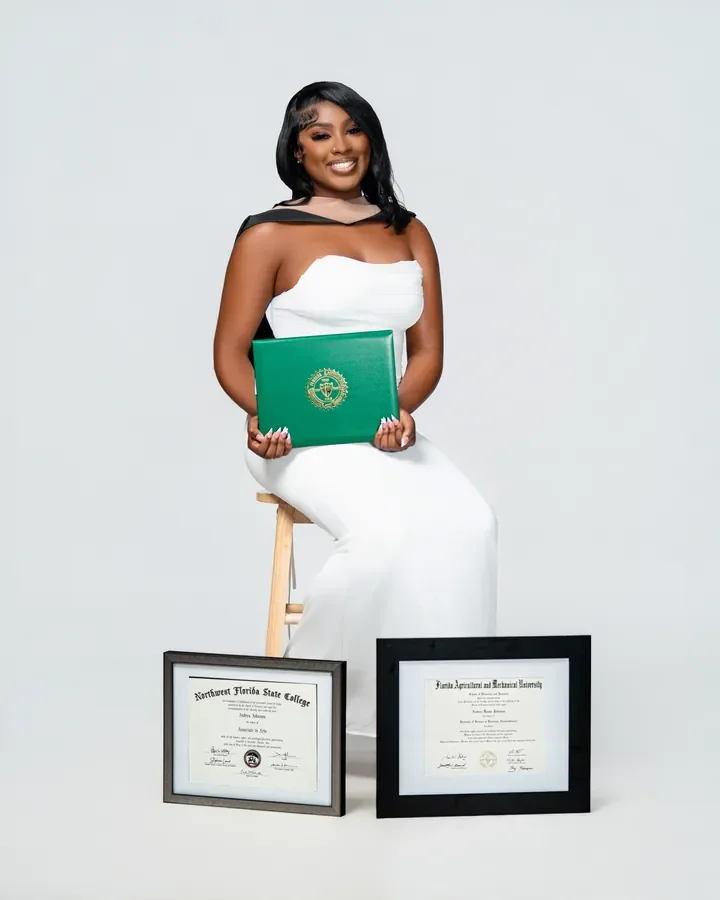 Seated graduate with a diploma and framed certificates — Smooth Studios