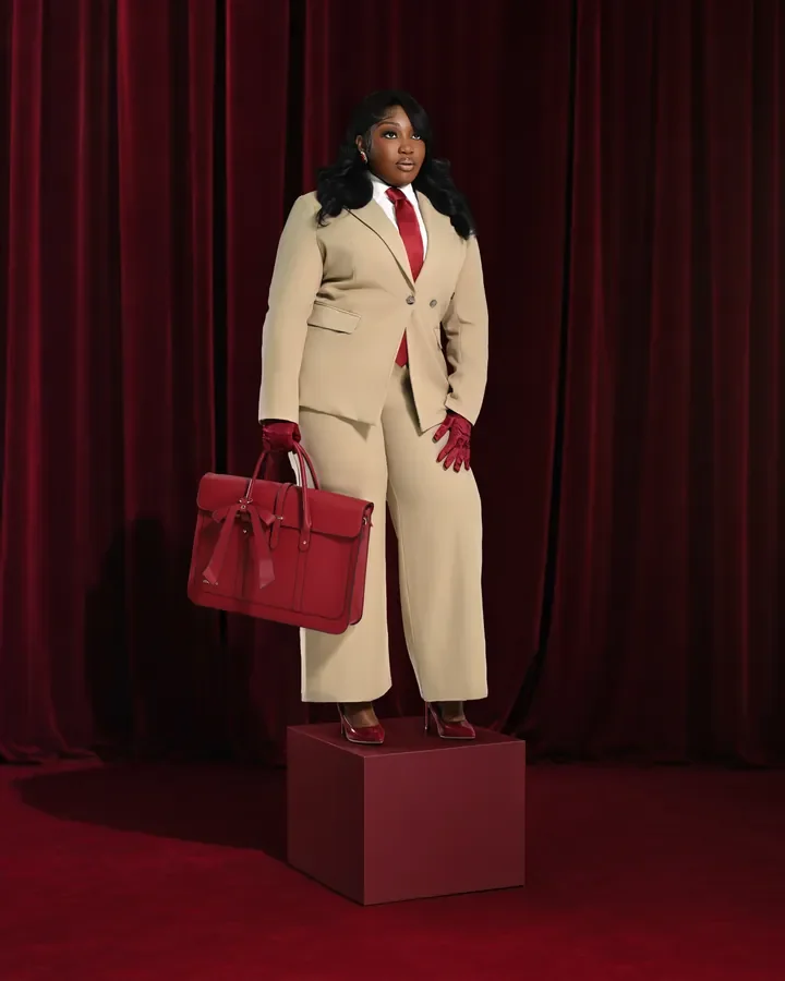 Fashion portrait in a cream suit against red curtains — Smooth Studios