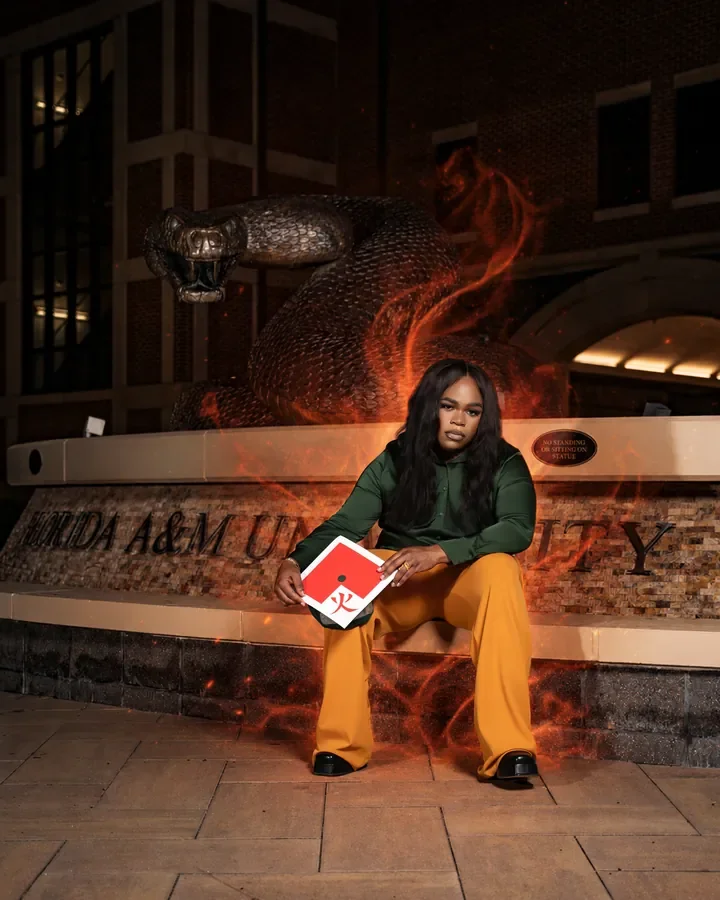 Graduate with a book outside a campus fountain — Smooth Studios