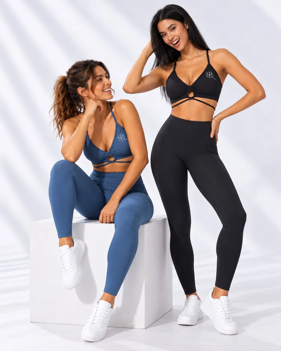 MIQ models in blue and black activewear sharing a lighthearted studio moment