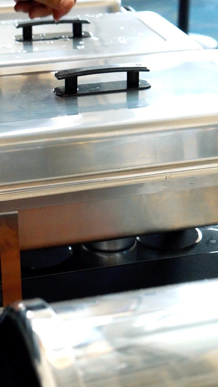 Stainless steel chafing dishes set up for buffet service